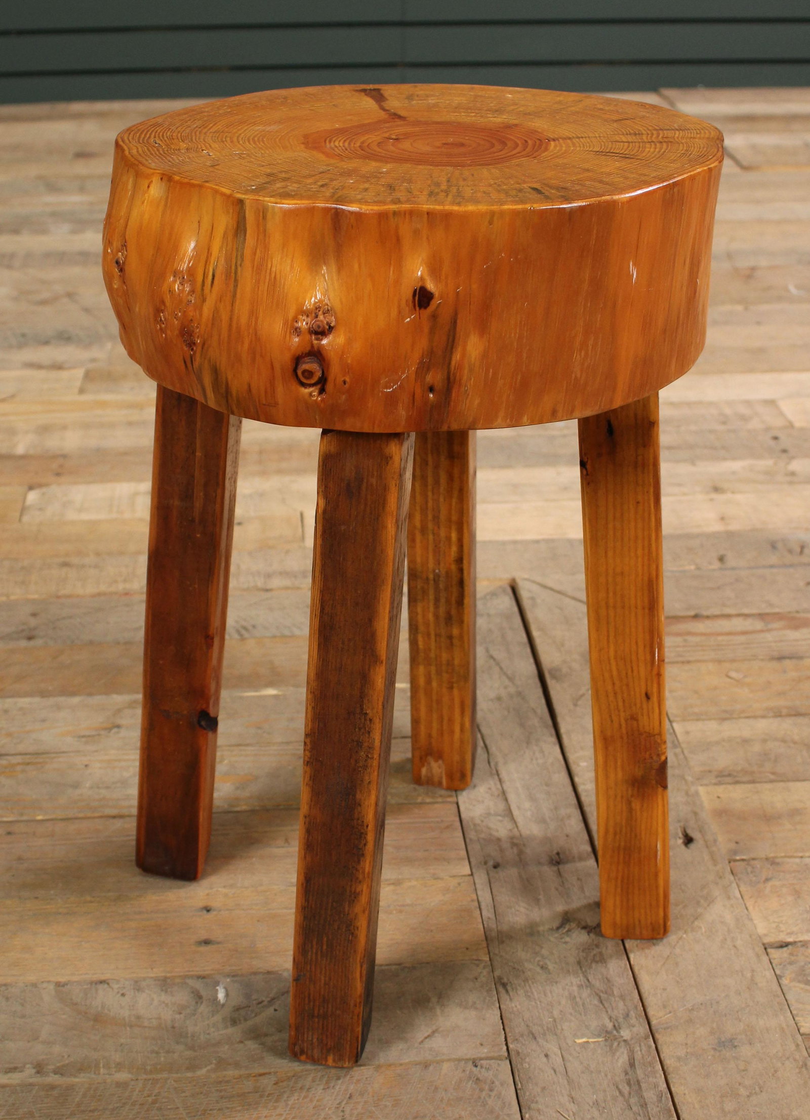 Natural Wood Stump Form Stool or Side Table: Natural Wood Stump Form Stool or Side Table, with a rustic influence all supported on legs. Size: 17.5" H x 10.5" Diameter.