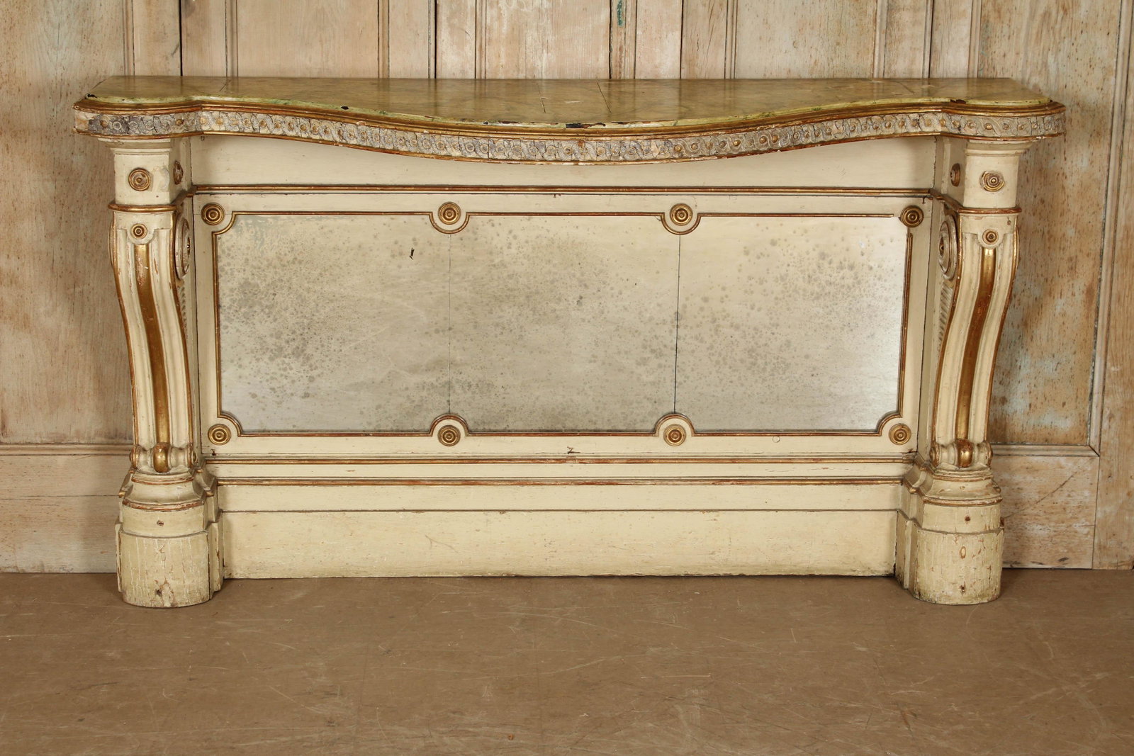 Continental 19th C Console: Continental 19th C Console. With faux marbleized top over carved volute supports and mirrored back. Size: 38.5" x 69.5" x 21