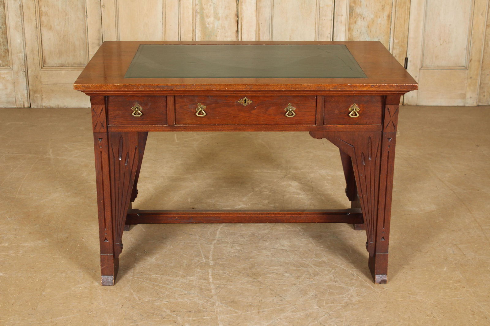 Arts & Crafts to Art Nouveau Transitional Desk: A very interesting Arts & Crafts to Art Nouveau transitional desk having inset leather top over three drawers and cattail decorated base. Size: 30"H x 43"W x 28"D