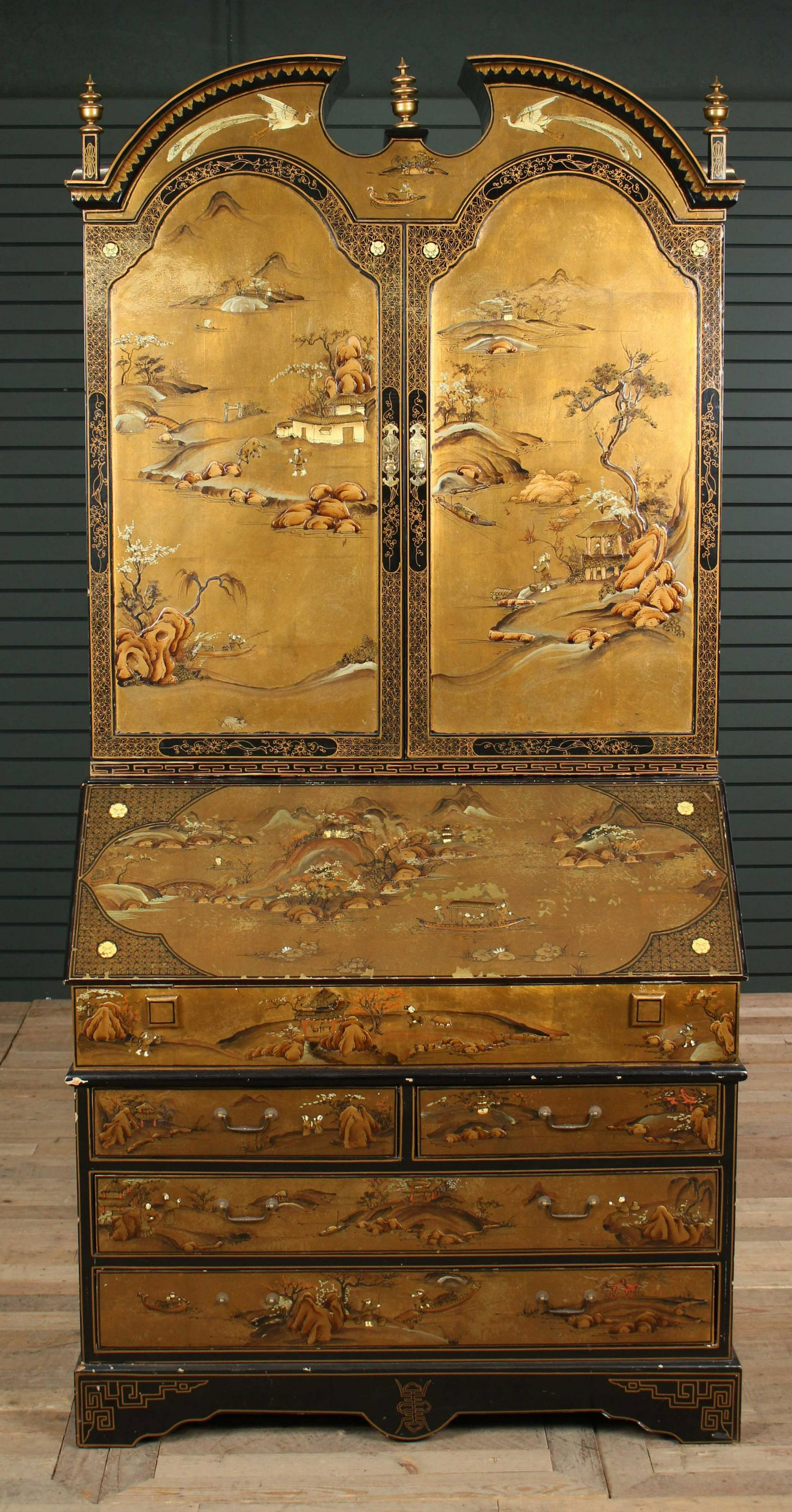 2 Piece Asian Chinoiserie Decorated Secretary Desk: Two Piece Asian Chinoiserie Decorated Secretary Desk, gilt and black lacquer having figural and landscape scenes, two doors having gilt and red lacquered fitted interior, above drop front with fitted 