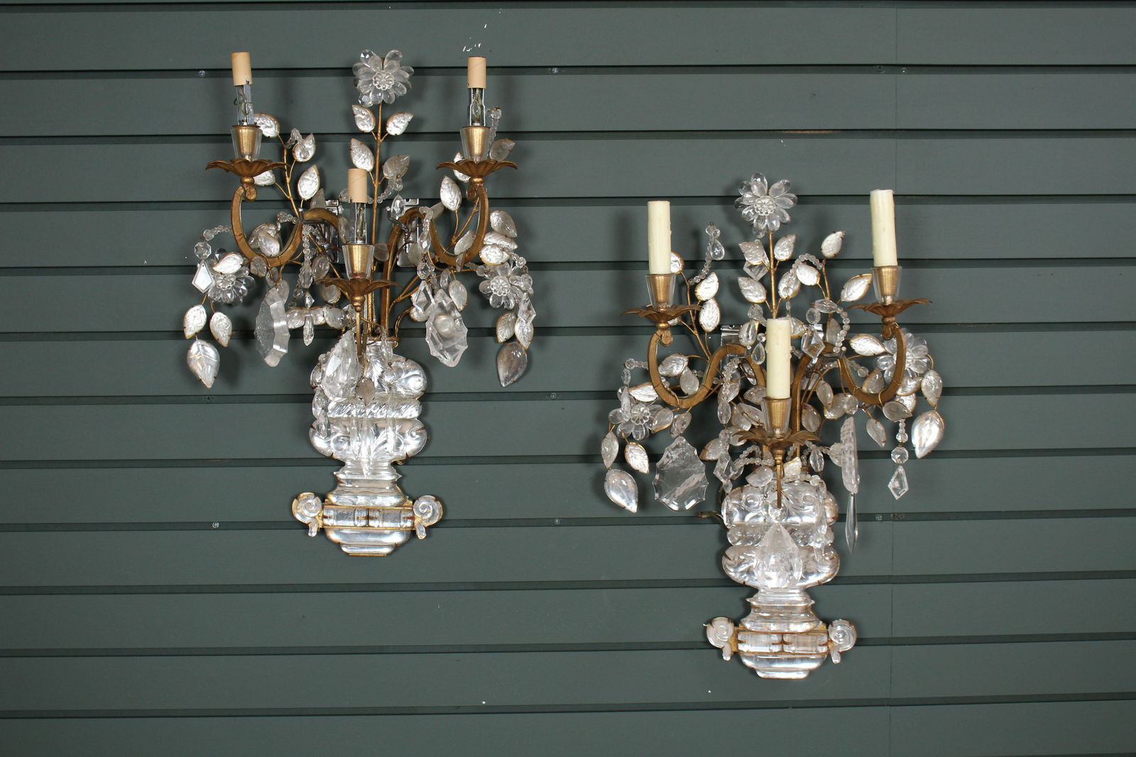 Pair of Maison Bagues Attr. Rock Crystal Sconces: Pair of Maison Bagues Attributed Rock Crystal Sconces each having 3 arms framed by stylized leaves and drop crystals above a decorated urn. Size: 23" H x 14" W x 8" D.