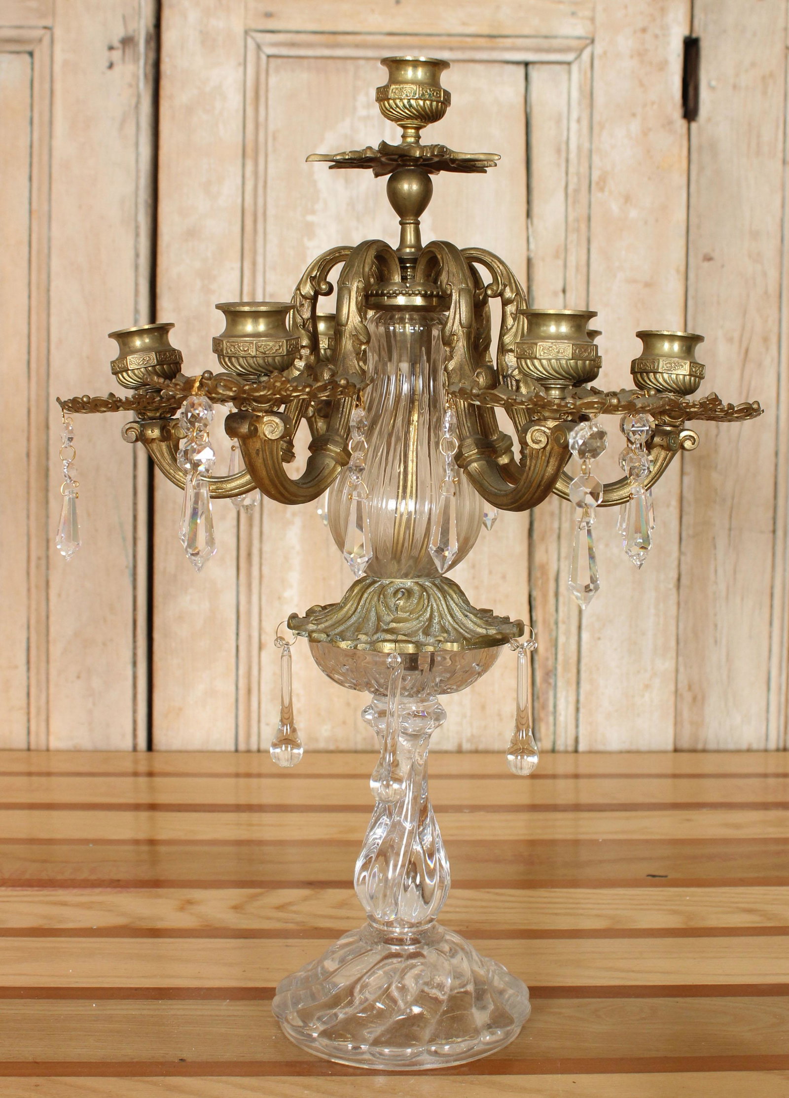 Bronze and Crystal Girandole Candelabra: Bronze and Crystal Candelabra with prisms, having six arms with a central candle holder. Size: 19.75" H x 14.5" W x 13.25" D