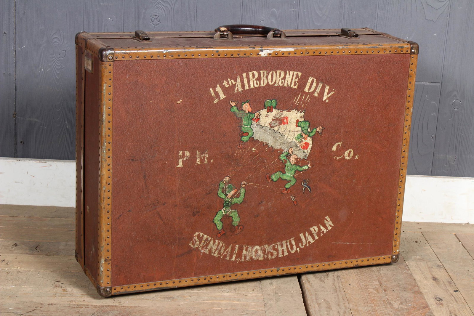 Hand Painted 11th Airborne Division Valise: Hand Painted 11th Airborne Division Valise, paratrooper's bag painted on both sides, depicting on one side "11th Airborne Div. P IT. Co. Sendai, Honshu, Japan" with image of paratroopers, other side d