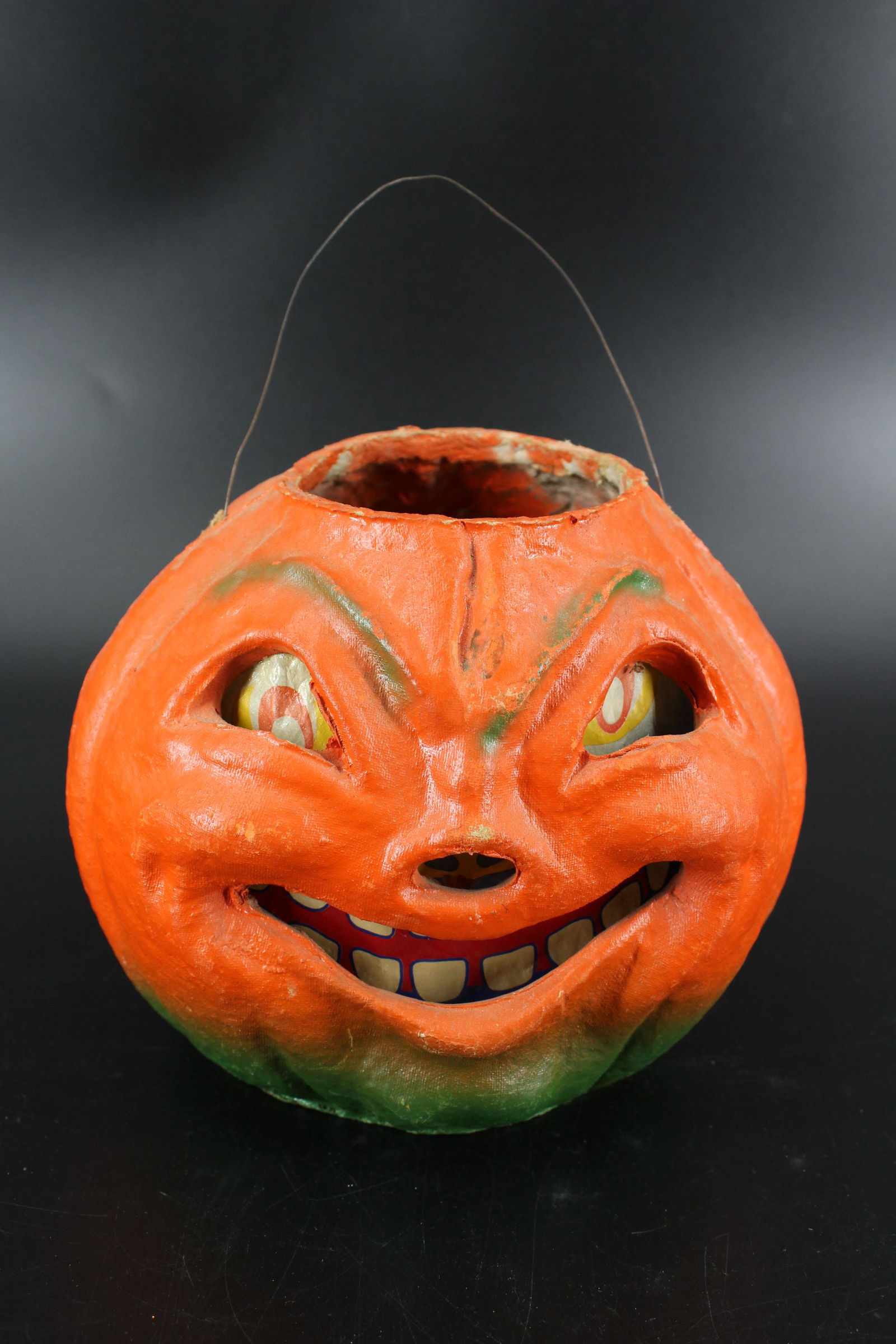 Vintage Papier Mache Pumpkin Jack-O-Lantern: Vintage Papier Mache Pumpkin Jack-O-Lantern, paper insert, wire handle, metal candle holder with candle. Size: 7" H x 8.5" W x 7.5" D.