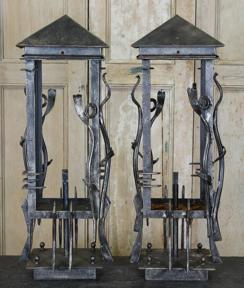 Pair Wrought Iron Lanterns: A pair of Art Nouveau style wrought iron lanterns having applied free form and geometric decoration. Size: 33" H x 12" W x 12" D