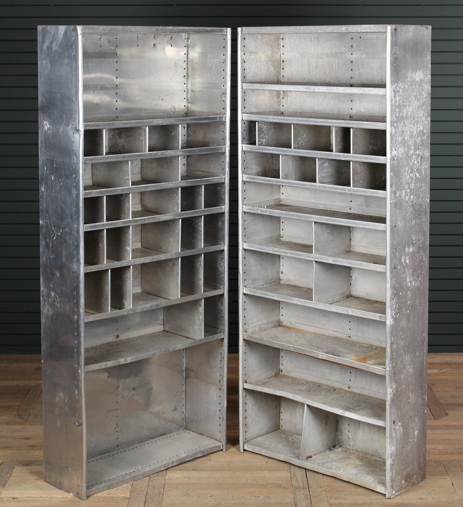 Pair of Industrial Metal Shelving Units: Pair of Industrial Metal Shelving Units, possibly aluminum, each with multiple compartments. Size: 85.5" H x 36" W x 13" D.