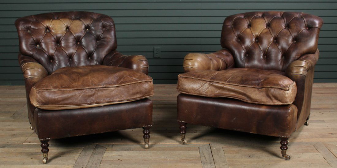 Pair Labeled George Smith Leather Club Chairs: Pair Labeled George Smith Leather Club Chairs, each having tufted backs and arms framing loose cushion seat, all raised on turned legs. Size: 33" H x 34" W x 39" D.