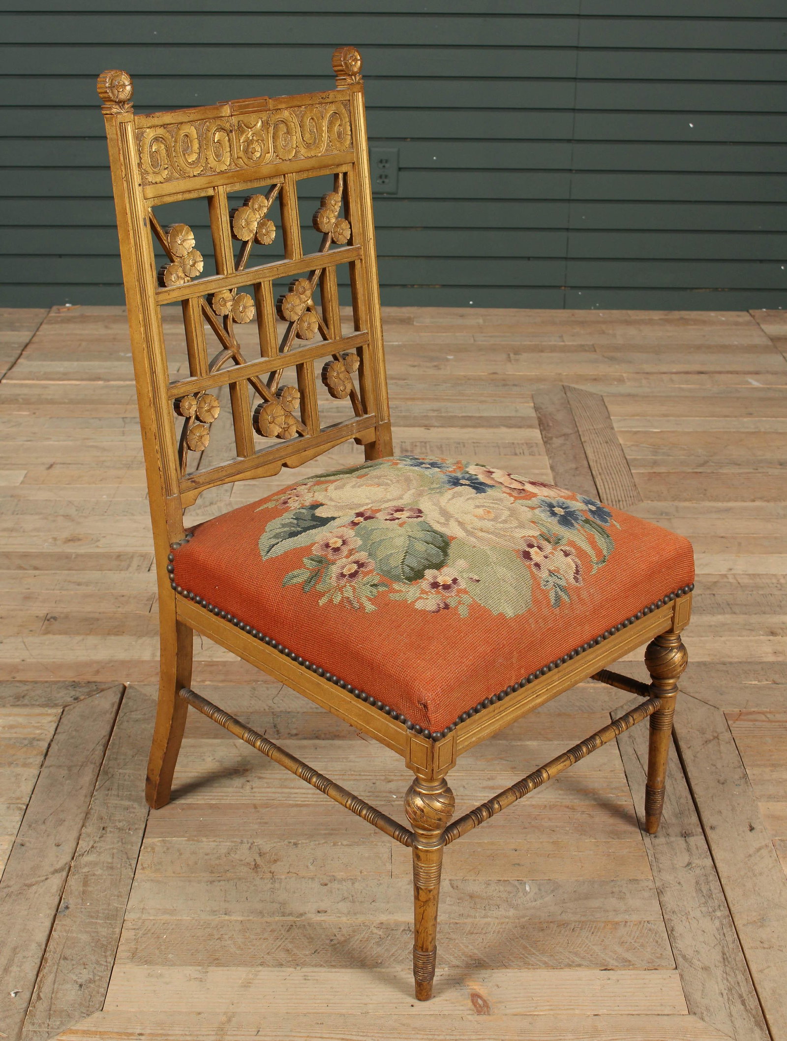 Late 19th C. American Victorian Carved Side Chair: Late 19th C. American Victorian Carved Side Chair, gilt wood carved chair, having stylized flower and branch back splat over a needlepoint seat. Size: 35" H x 18" W x 18" D.