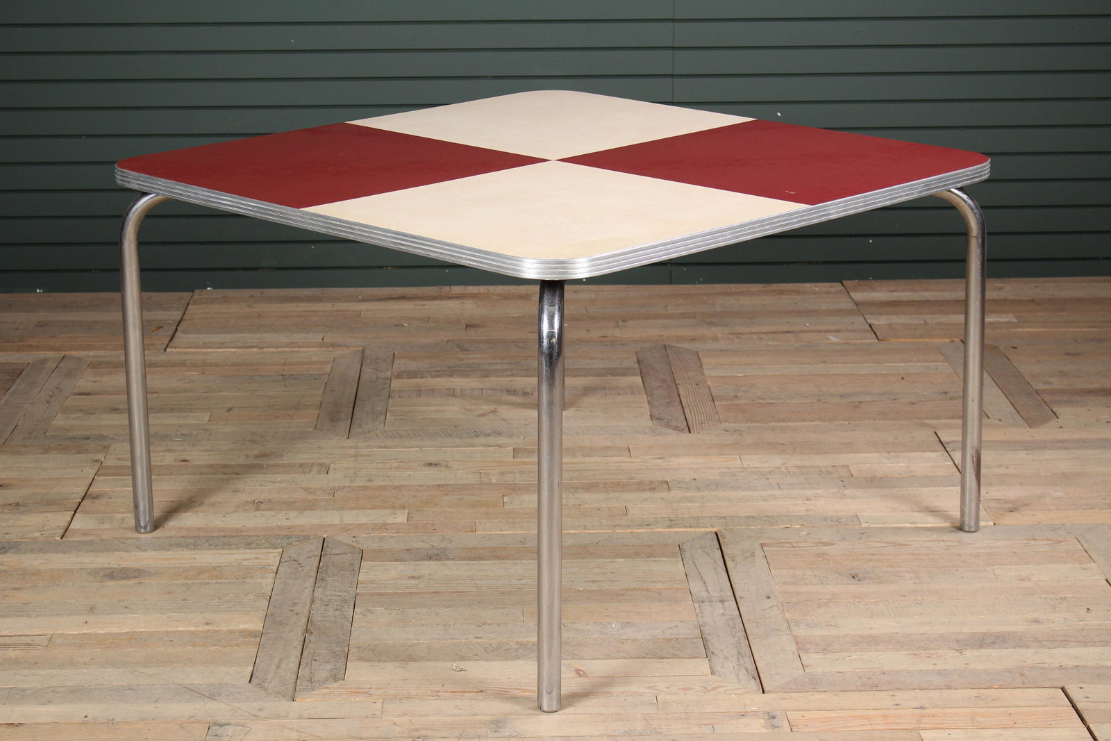 1950's Vintage Chrome & Linoleum Dining Table: 1950's Vintage Chrome & Linoleum Dining Table having red and white block color top, supported on chrome legs. Size: 29" H x 48" W x 48" D.