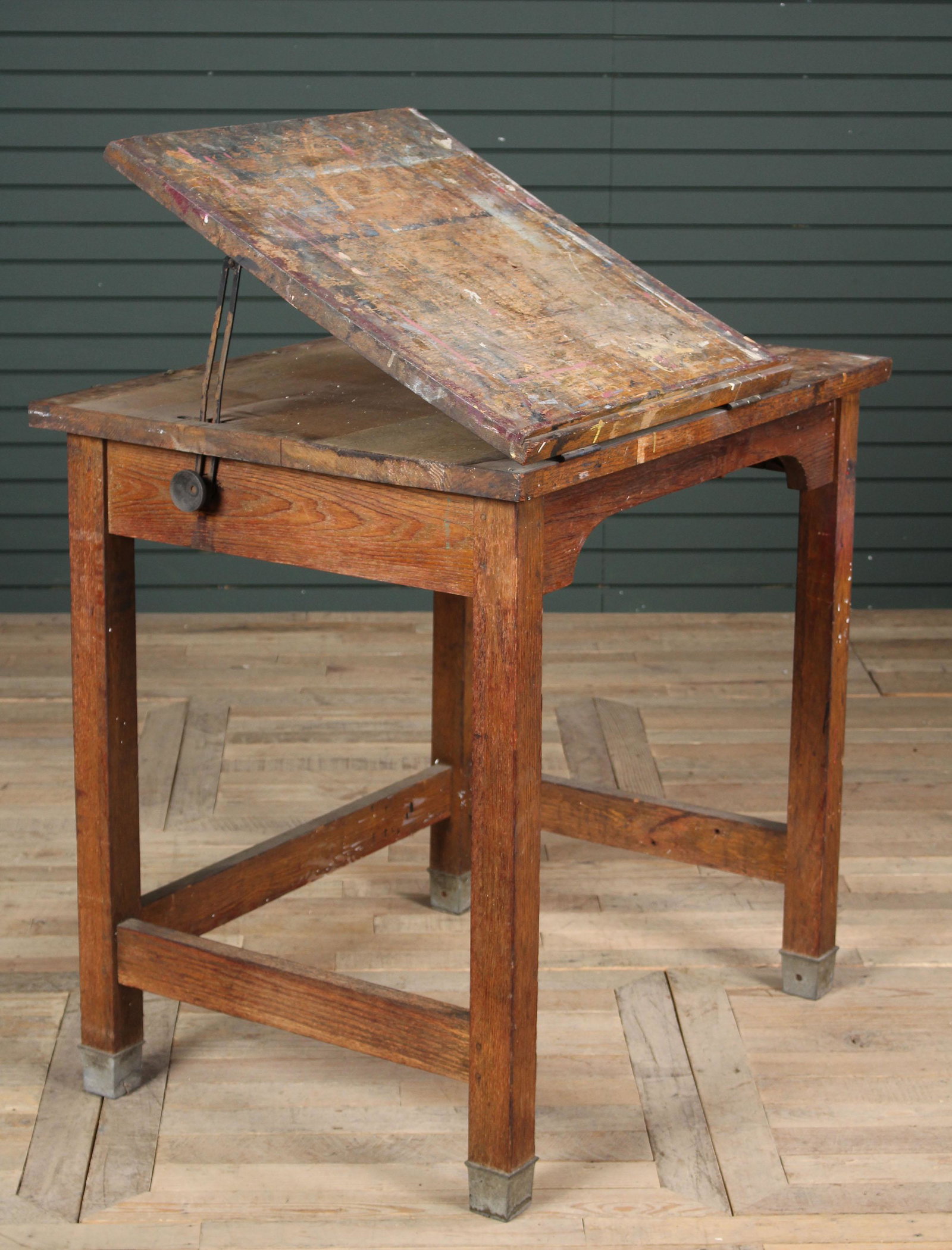 Turn of the Century Oak Architects Table: Turn of the Century Oak Architects Table having an adjustable top and overall paint splatter. Size: 37" H x 36" W x 28" D.