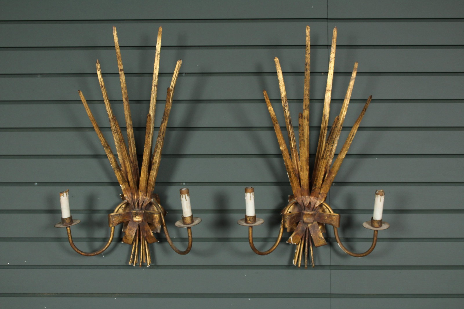 Pair Spanish Ferrocolor Gilt Metal Sconces: Pair of gilt metal feather sconces, each having central bow and 2 arms. Size: 25" H x 15.5" W.