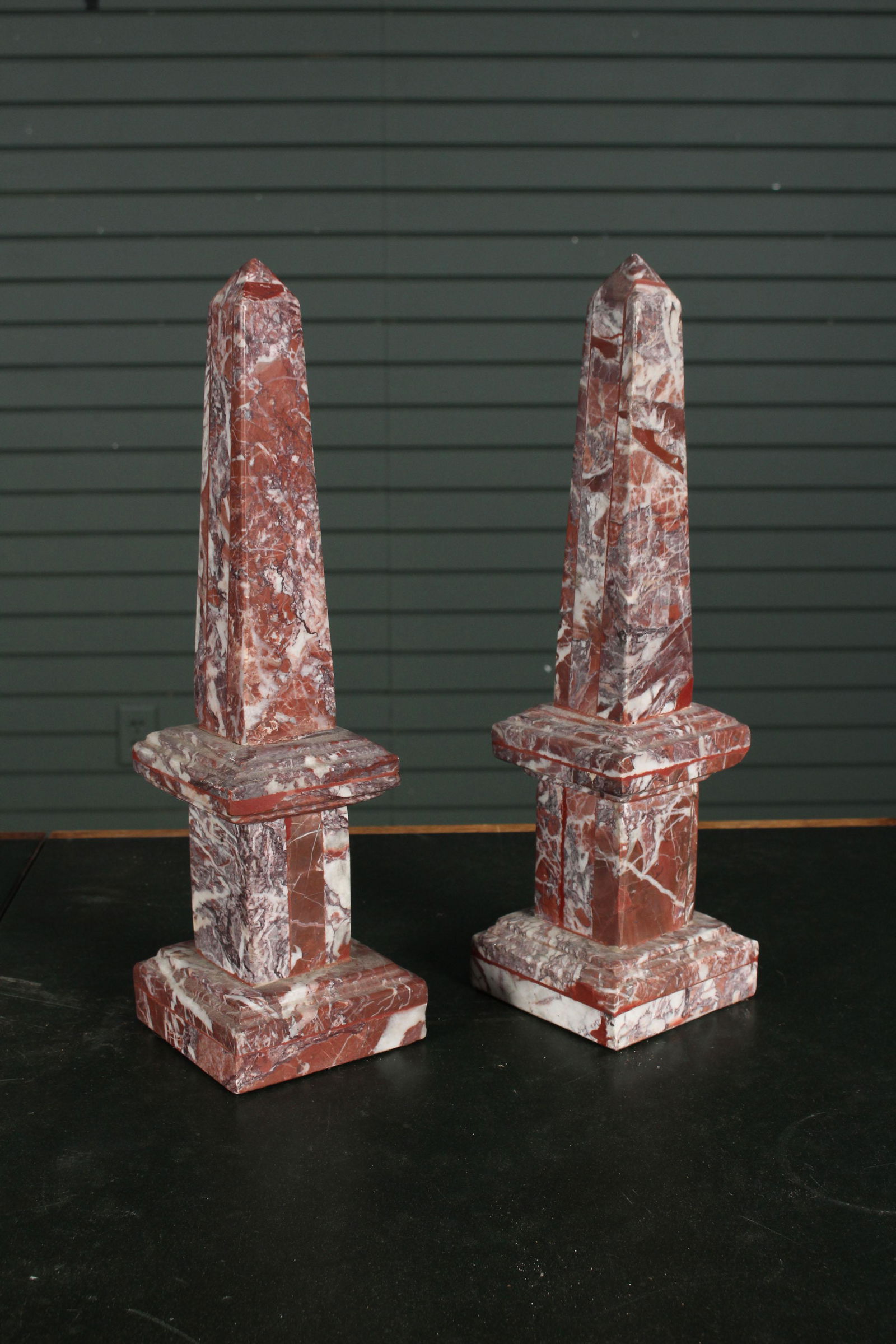 Pair of Neoclassical Carved Marble Obelisks: Pair of Neoclassical Carved Marble Obelisks in the Grand Tour style with central collar and stepped base. Size: 15.5" H x 4.5" W x 4.5" D.