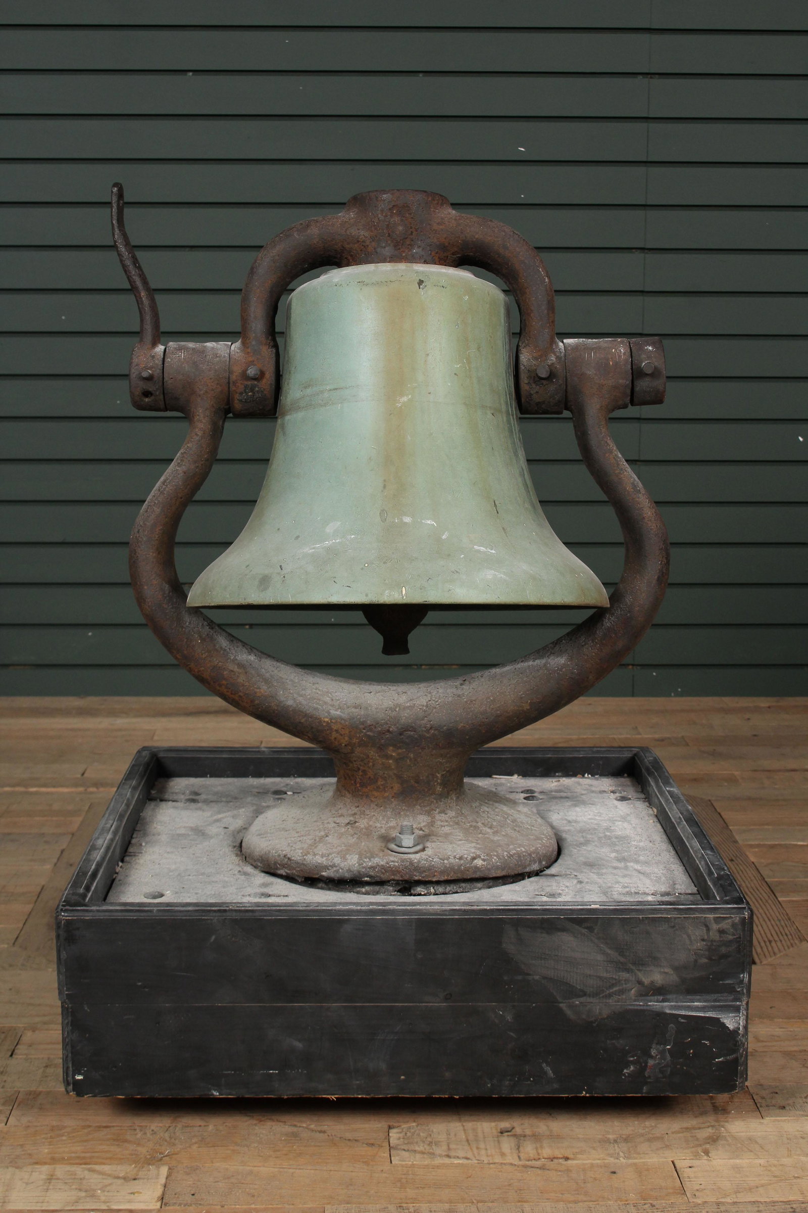 Antique Bronze and Cast Iron Locomotive Bell: Antique Bronze and Cast Iron Locomotive Bell retaining a verdigris patination and clapper, now mounted on rolling wood base. Size: Bell: 26" H x 21.5" W x 15" D.