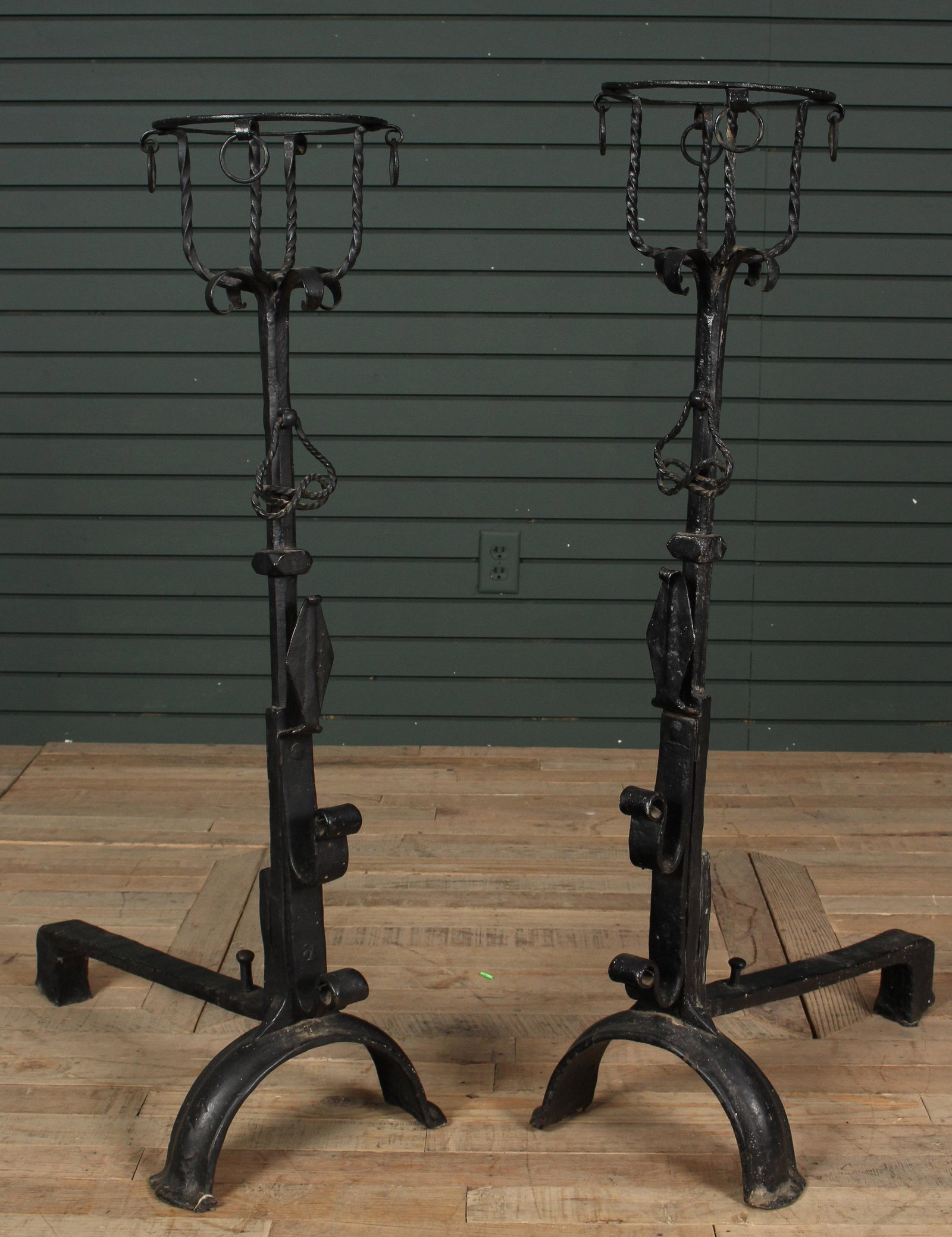 Monumental Pair of Wrought Iron Andirons: Monumental Pair of Wrought Iron Andirons in the 16th Century taste, each having peat baskets supported on hand forged posts. Size: 42.5" H x 14" W x 26.5" D.