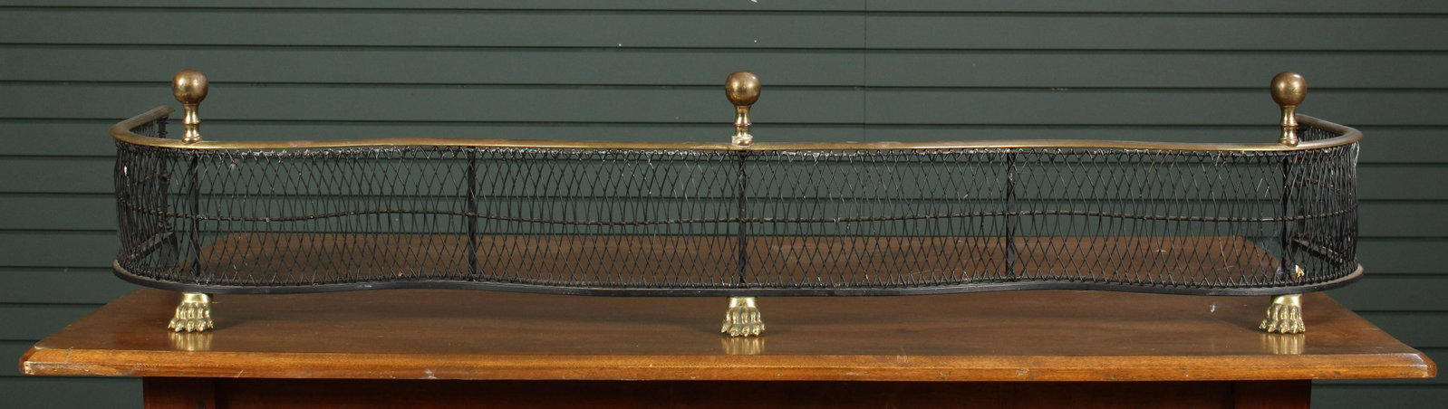 English Regency Style Serpentine Front Fireplace: English Regency Style Serpentine Front Fireplace Fender with brass ball finials and paw feet. Size: 9" H x 48" W x 13" D.