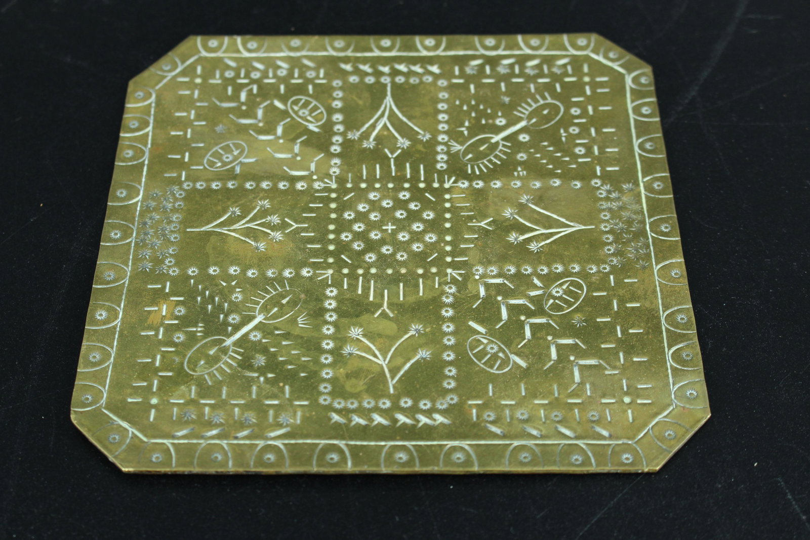 Brass Engraved Plaque or Trivet: Brass Engraved Plaque or Trivet, incised floral and symbolic decoration on top. Size: 6" H x 6" W.