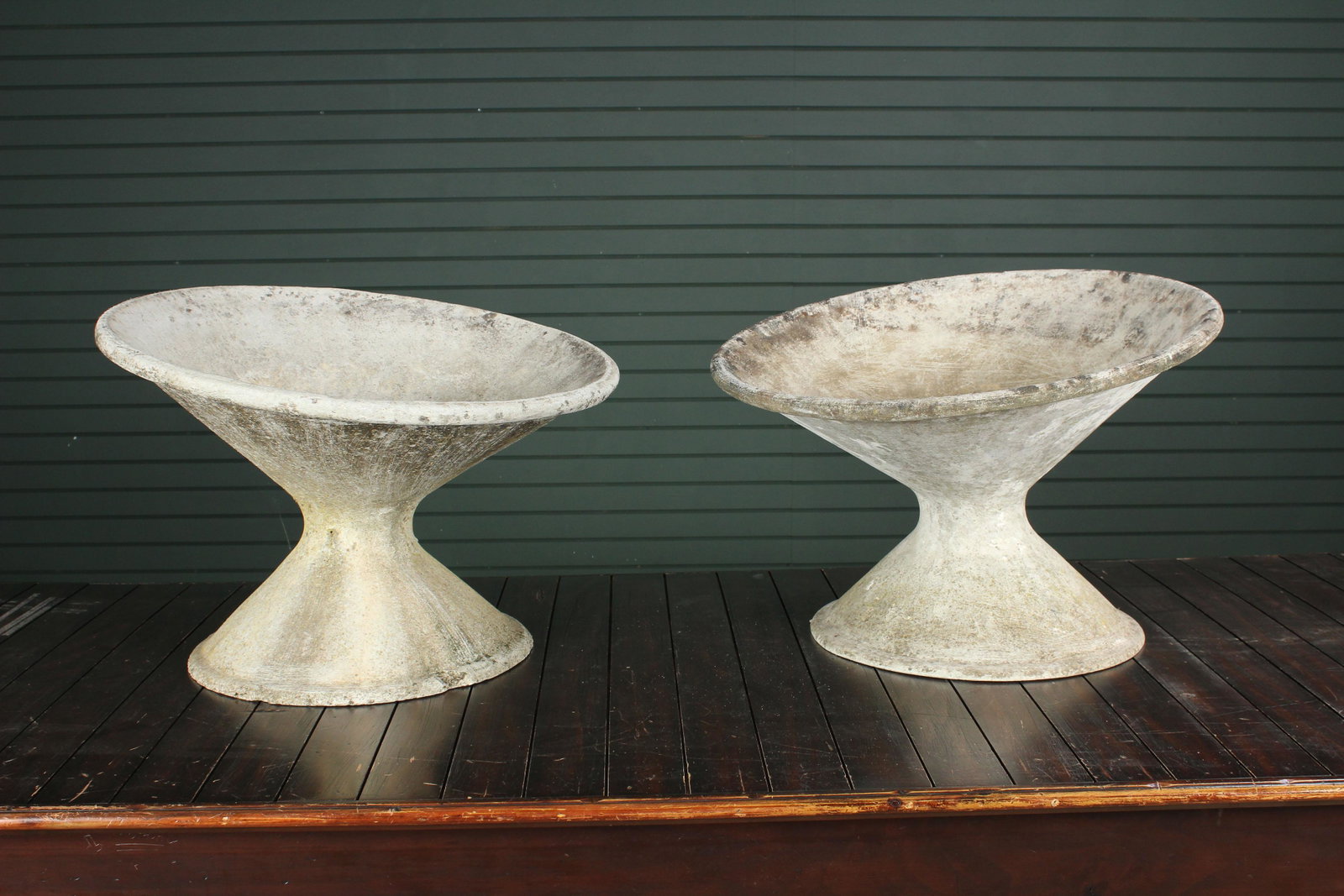 Pair Canted Hourglass Willy Guhl Planters: A good pair of Willy Guhl canted hourglass garden planters. Size: 18" H x 25" diameter.