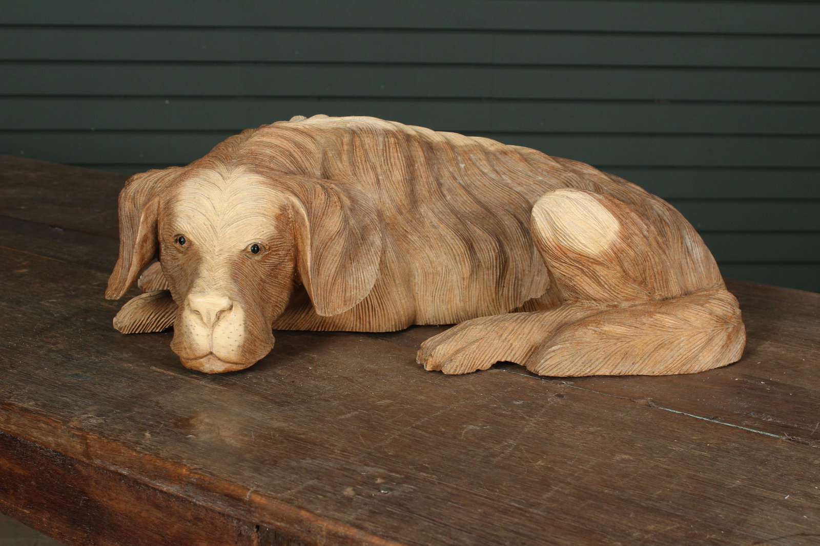 Carved Wood Recumbent Dog: Carved Wood Recumbent Dog. With glass eyes. Size: 6.5"H x 20"W x 10"D
