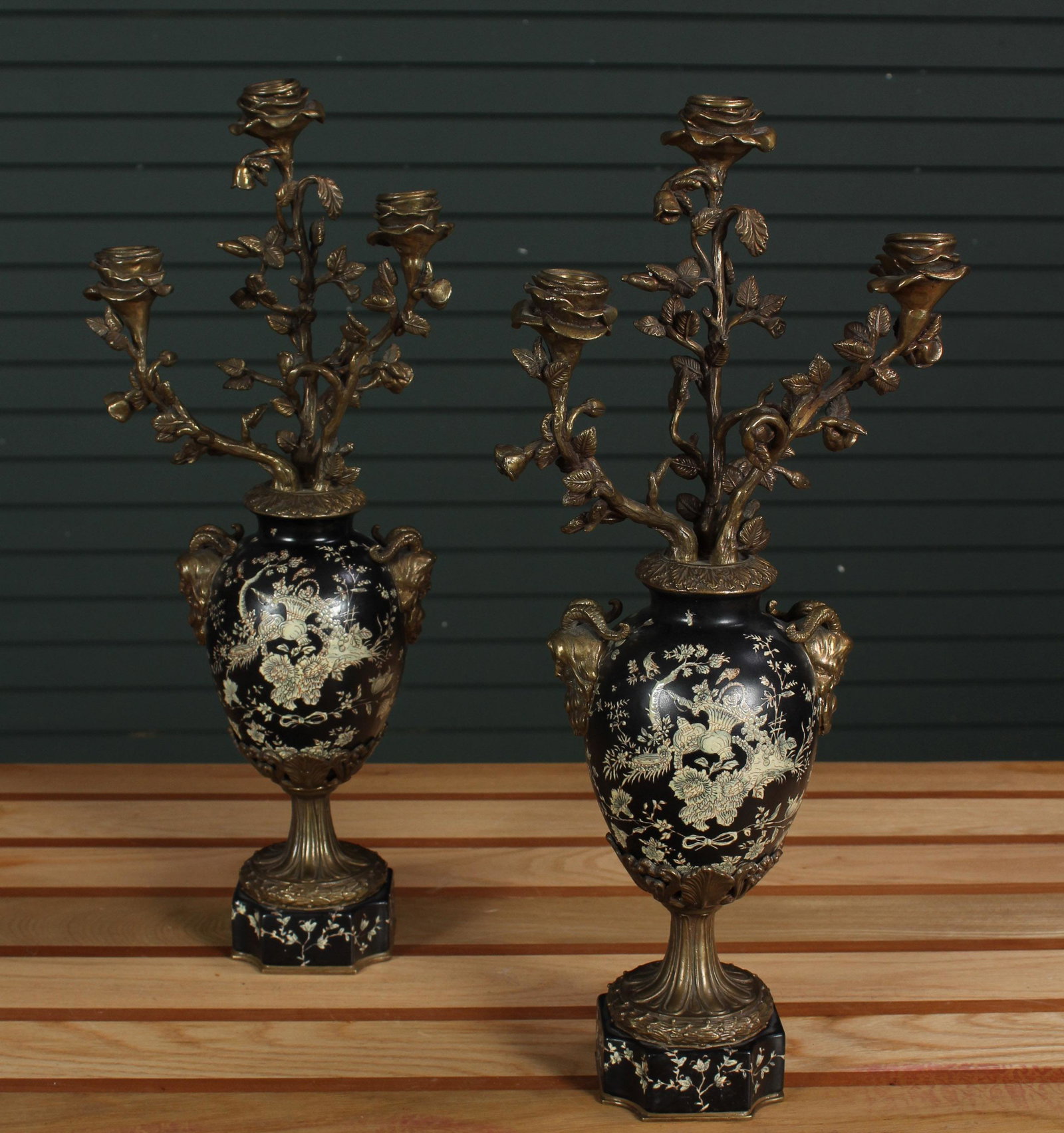 Pair of Bronze and Slate Garnitures: Pair of Bronze and Slate Garnitures, triple arm candelabra, bronze arms with floral and foliate design, bronze mask head handles, inlaid floral and foliate decoration to body and base. Size: 21.5" H x