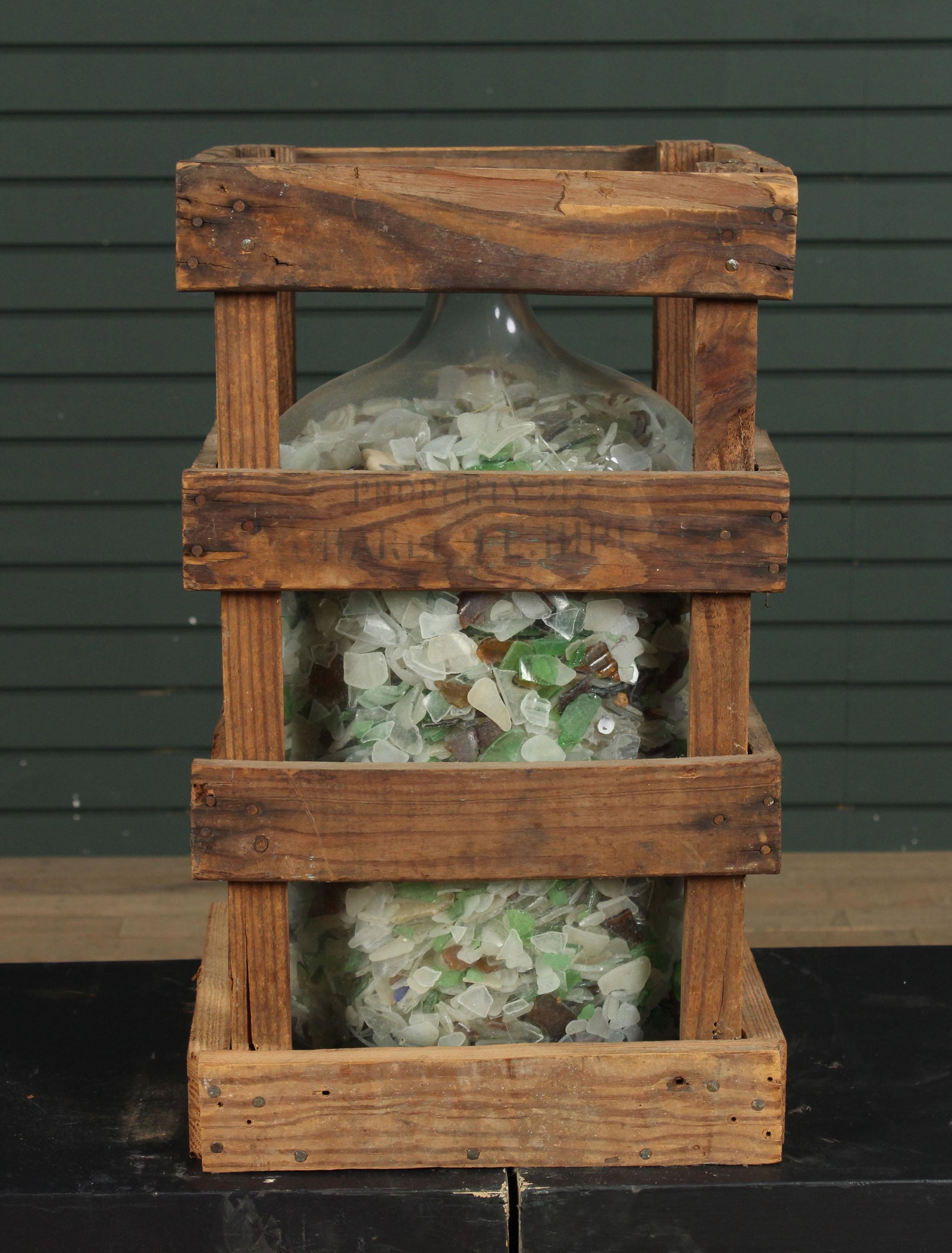 Collection of Sea Glass in a Carboy and Crate: Collection of Sea Glass in a Carboy and Crate. Size: 21" x 12" x 12" crate.