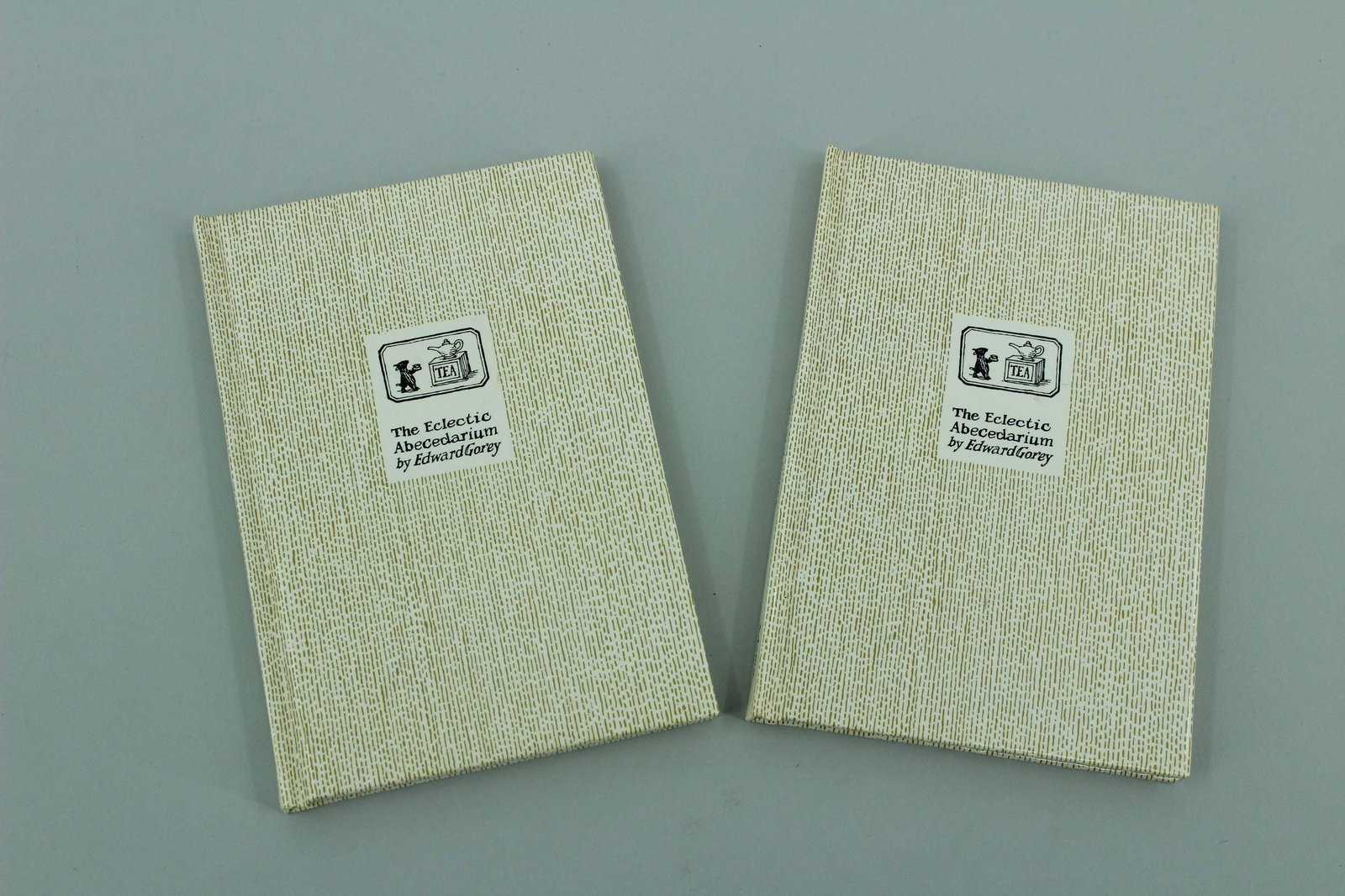 2 Copies of The Eclectic Abecedarium: 2 Copies of The Eclectic Abecedarium by Edward Gorey, published by Adama Books, New York, 1983. Reprint edition. Size: 6"H x 4"W