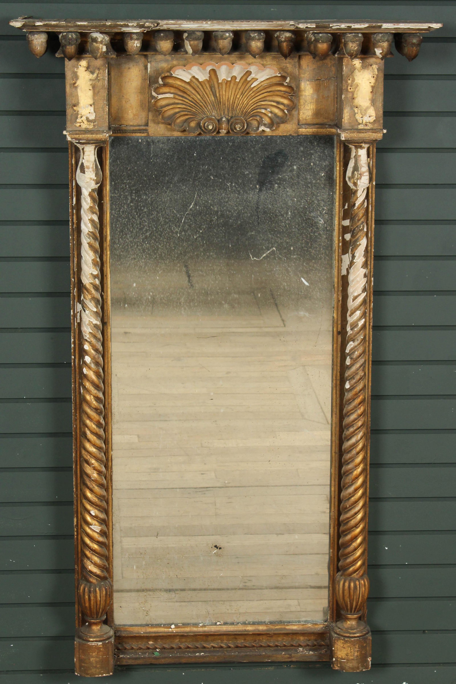 Antique Gesso Over Wood Mirror: An antique gilt gesso over wood mirror having twist columns, and clamshell crest with a stepped acorn decorated cornice. Size: 54.5" H x 33" W x 8.5" D