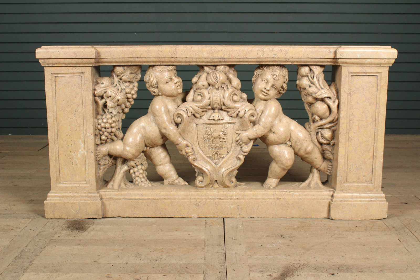 Continental Carved Marble Heraldic Frieze: Continental Carved Marble Heraldic Frieze. Profusely carved in the round with putti, festoons, and shield. Size: 29.5" x 59" x 9.5"