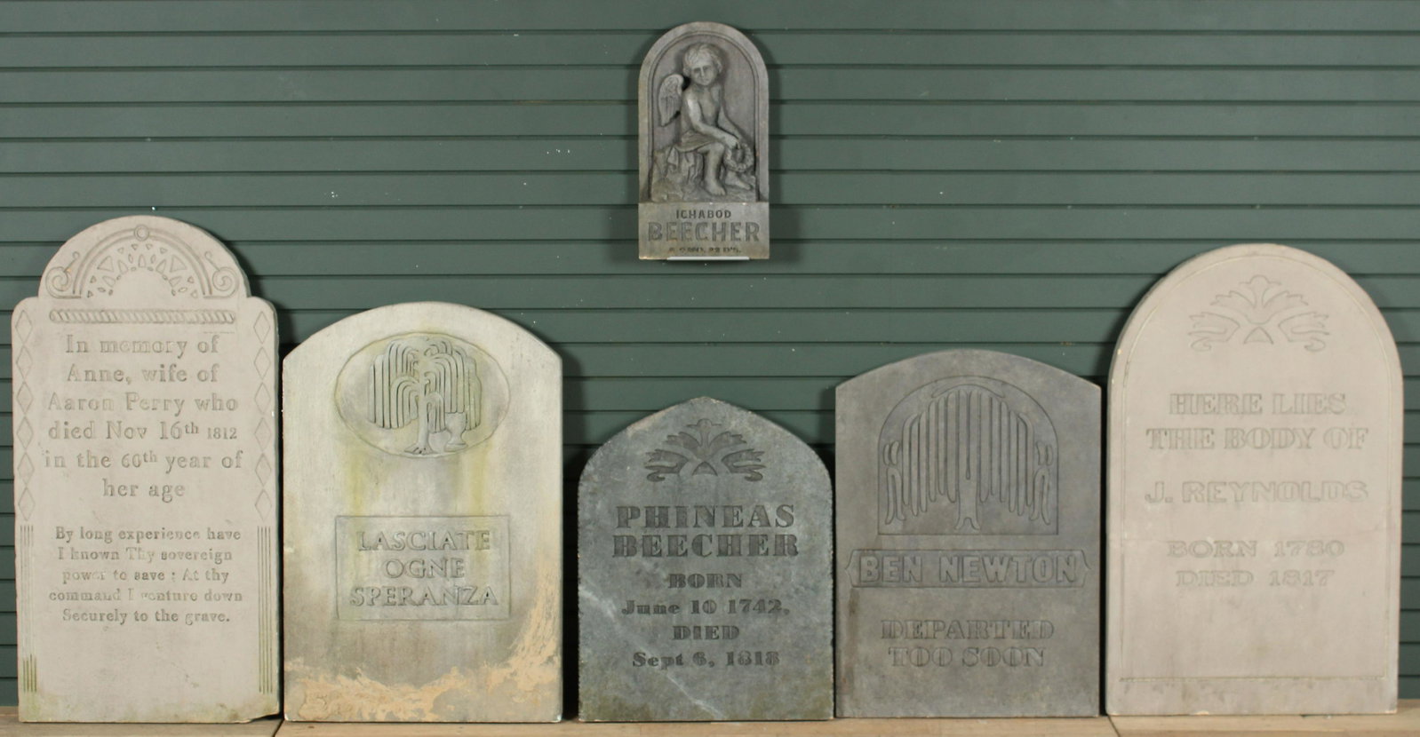 Six 18th and 19th C Style Gravestone Props: Six 18th and 19th C Style Gravestone Props. New. Stucco over foam core. Including the Beecher Baby and Ben Newton. Size: Largest: 44" H x 23" W x 2" D Provenance: Production of â€œDickinson”