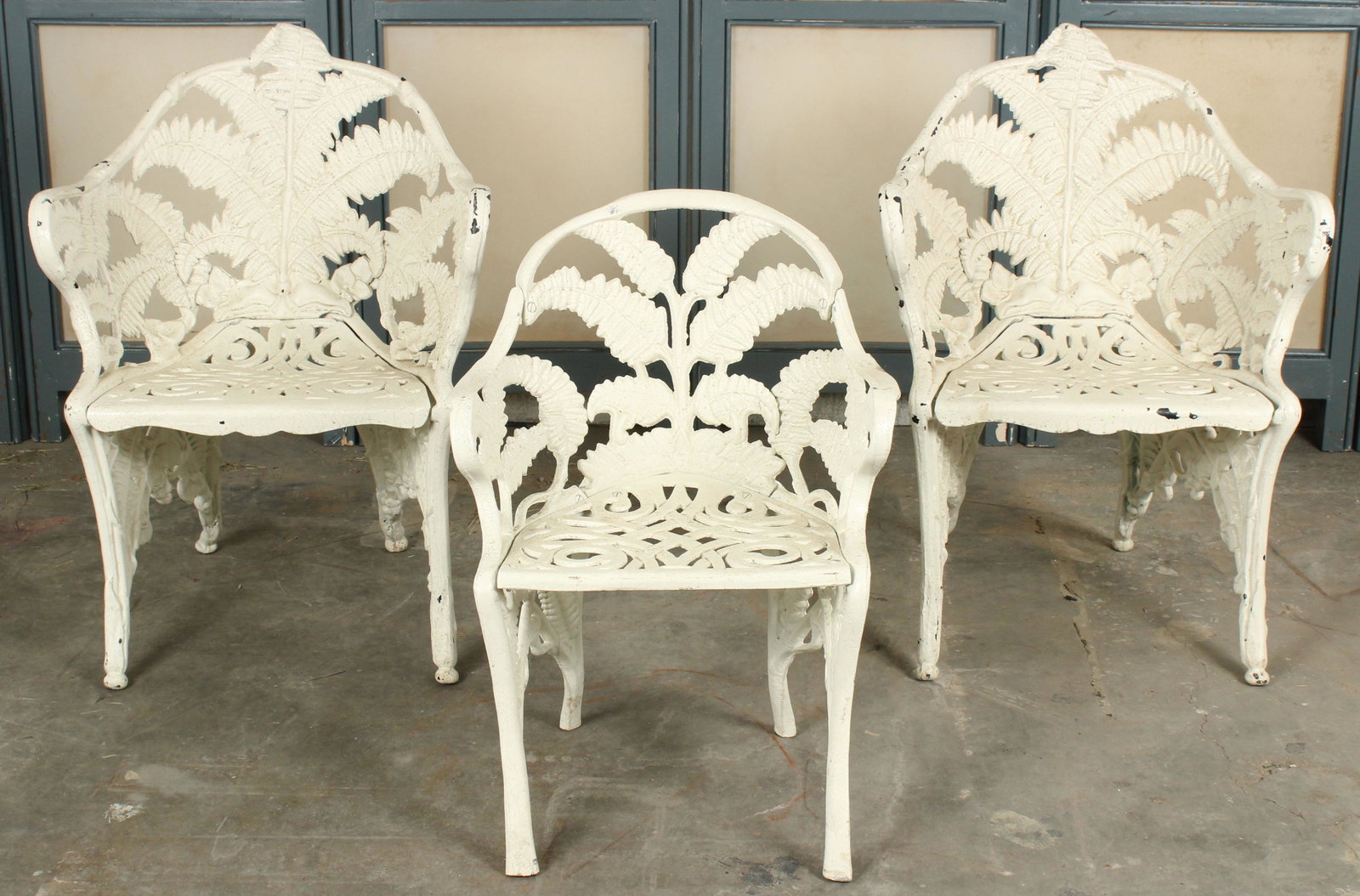 Family Group 3 Cast Aluminum Fern Garden Chairs: 2 adult sized and 1 child sized painted cast aluminum garden chairs having fern decoration throughout the arms, legs, and back. Size: Largest: 34" H x 25" W x 21.5" D Provenance: Production of â€œ