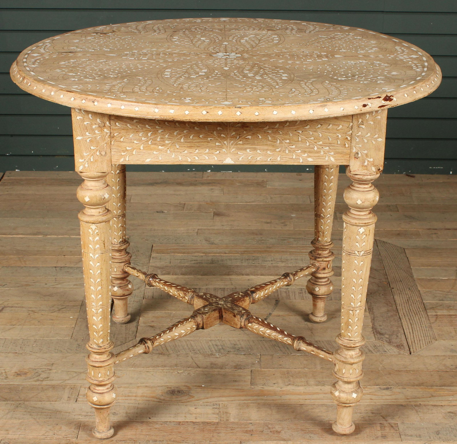 Anglo-Indian Bone Inlaid Center Table: A good antique Anglo Indian stripped and bone inlaid center table with scroll and leaf decorated top and legs. Size: 30.5" H x 36" W x 36" D