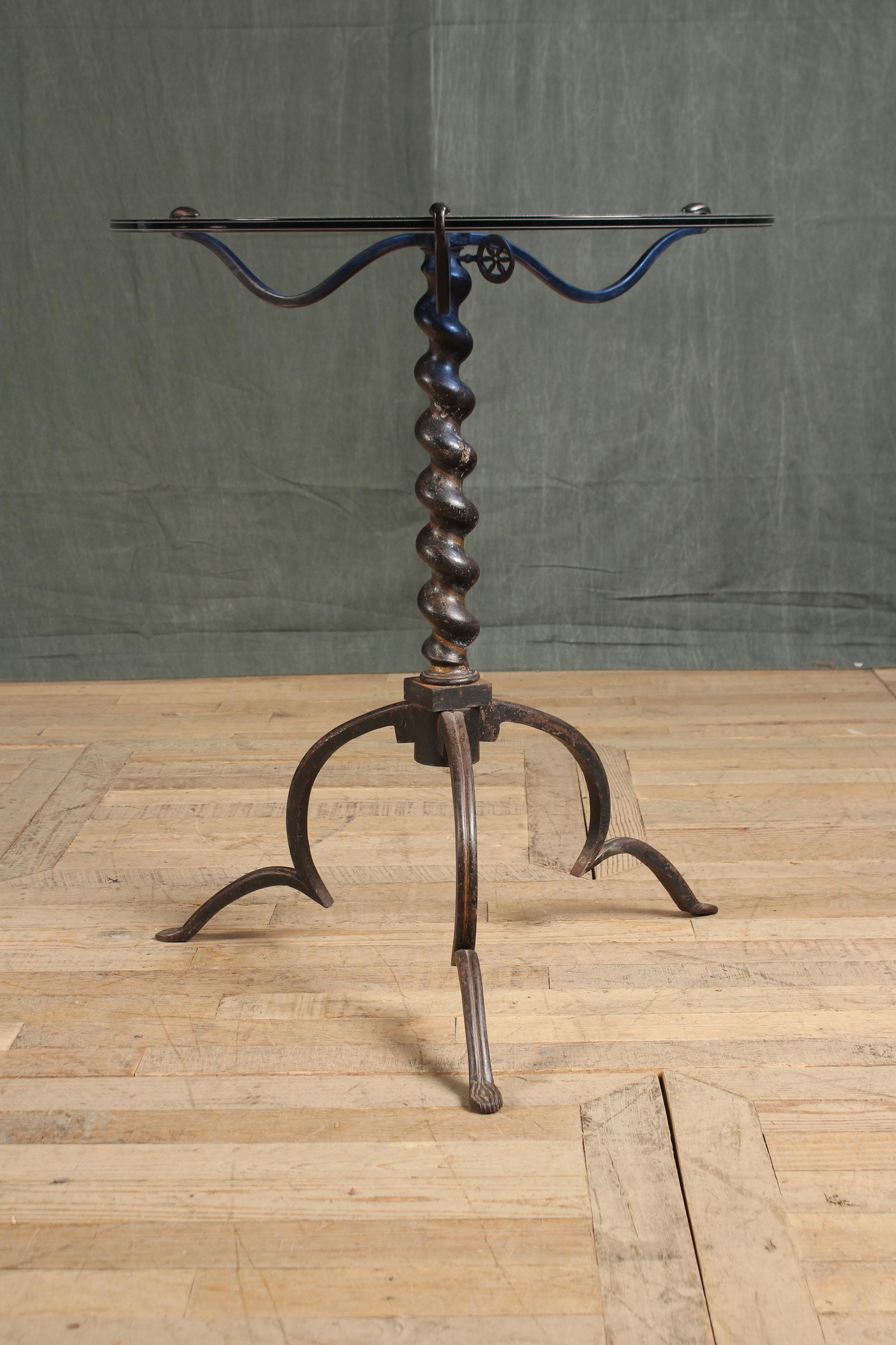 Wrought Iron Barley Twist Gueridon: A late 19th century to early 20th century wrought iron Gueridon having a smoked glass top supported on barley twist post and tripod base. Size: 31"H x 26"Dia.
