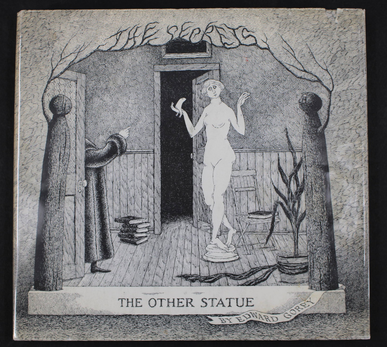 Edward Gorey, The Secrets...Other Statue, Signed: Edward Gorey, The Secrets: Volume One, The Other Statue, Signed. Simon and Schuster First Printing. Size: 6.75"H x 7.25"W