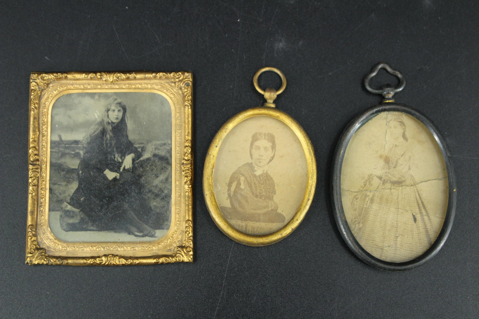 2 Early Black and White Photos & 1 Tintype: 2 Early Black and White Photos & 1 Tintype, two black and white photographs housed in oval frames, and one tintype in a square brass frame. Size: 3.25"H x 2.75"W