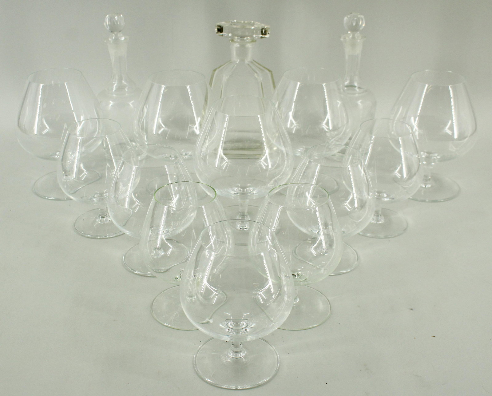 Group of Glass Decanters and Snifters: Group of Glass Decanters and Snifters. Size: Largest: 7.5" H x 4.5" W x 2.5" D