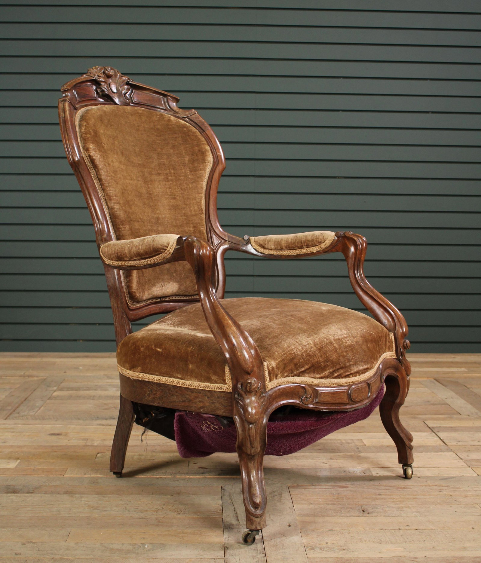 American Victorian Carved Rosewood Armchair: American Victorian Carved Rosewood Armchair, late 19th C., having floral carved crest rail over shaped arms and seat. Size: 40" H x 25" W x 23" D.