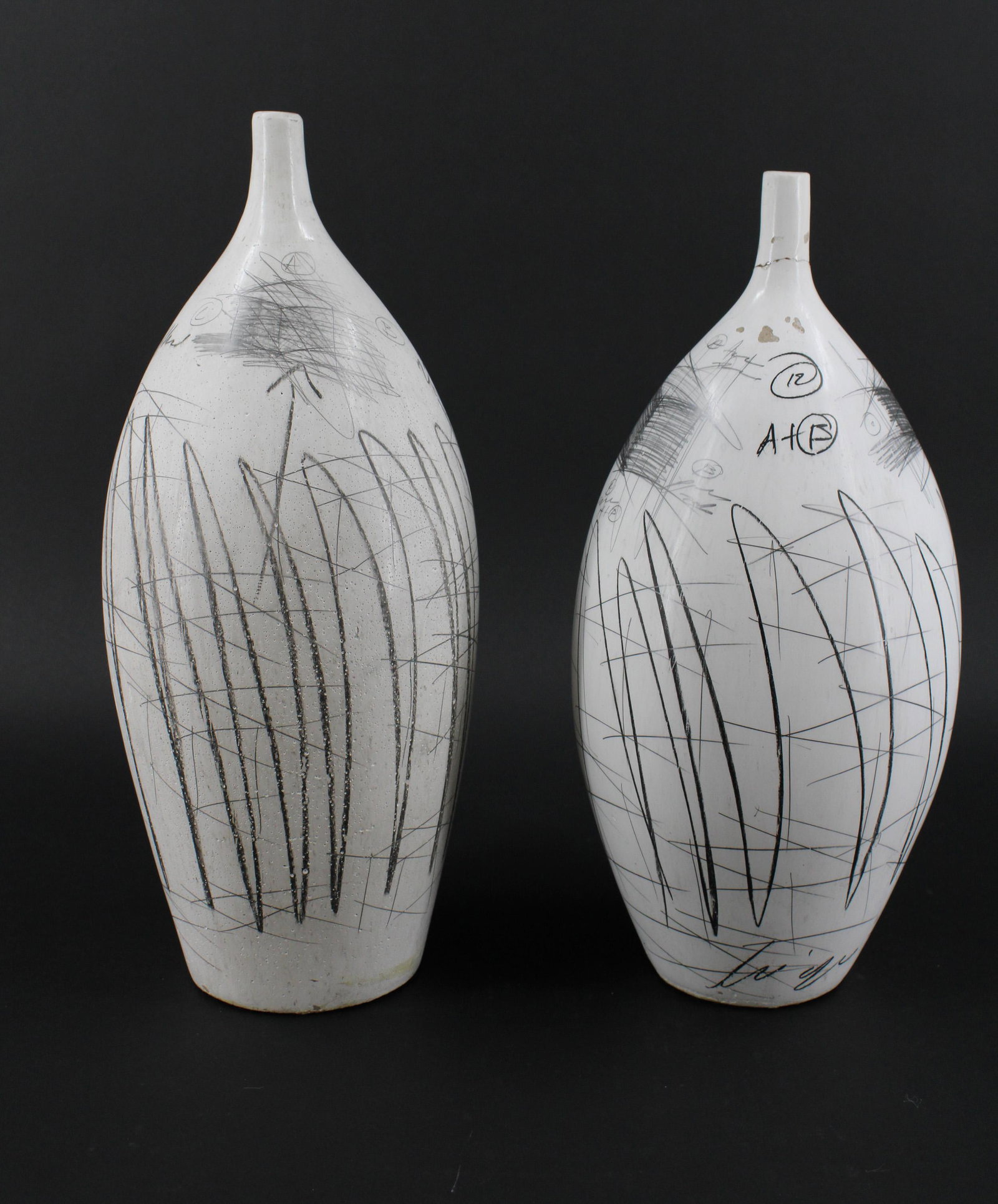 Mexican Art Pottery Vases: Mexican Art Pottery Vases. Size: 16"H x 6.5"W x6.5"D One has a repair to spout and both have glaze loss.