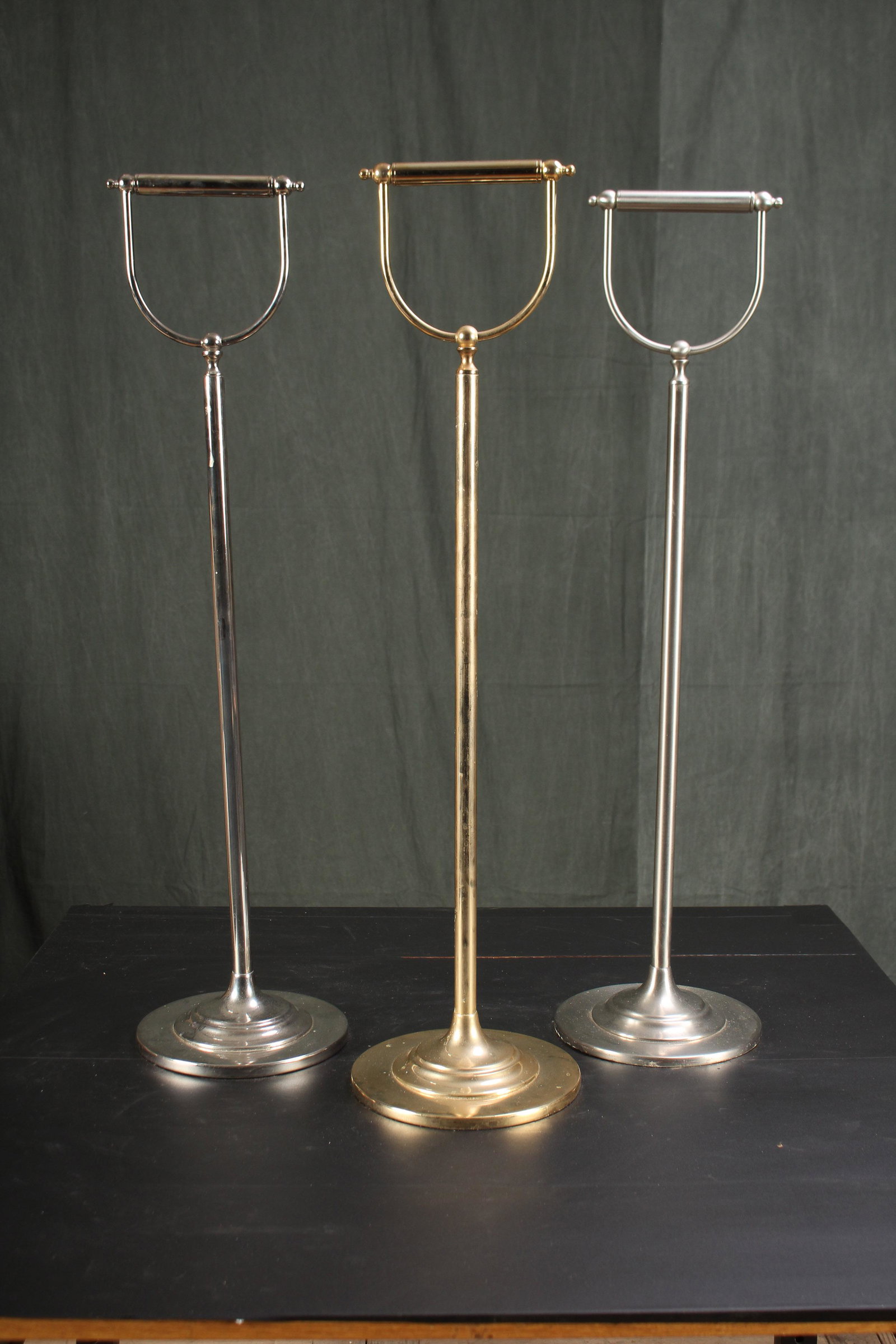3 Toilet Paper Stands in Various Finishes: 3 Toilet Paper Stands in Various Finishes. Nickel, brushed nickel, and brass. Size: 31" on 8" diameter base.