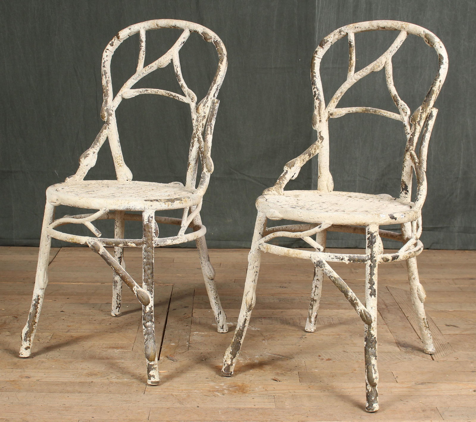 Pair of Painted Metal Faux Bois Garden Chairs: Pair of Painted Metal Faux Bois Garden Chairs with stylized back and round seat. Size: 36" H x 17.5" W x 18" D.