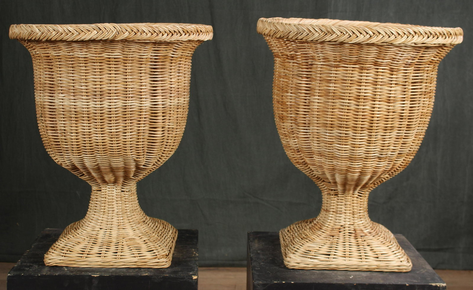 Pair Camapna Form Wicker Urns: A pair of Campana form wicker urns each having a flared rim and base. Size: 21"H x 18"Dia.
