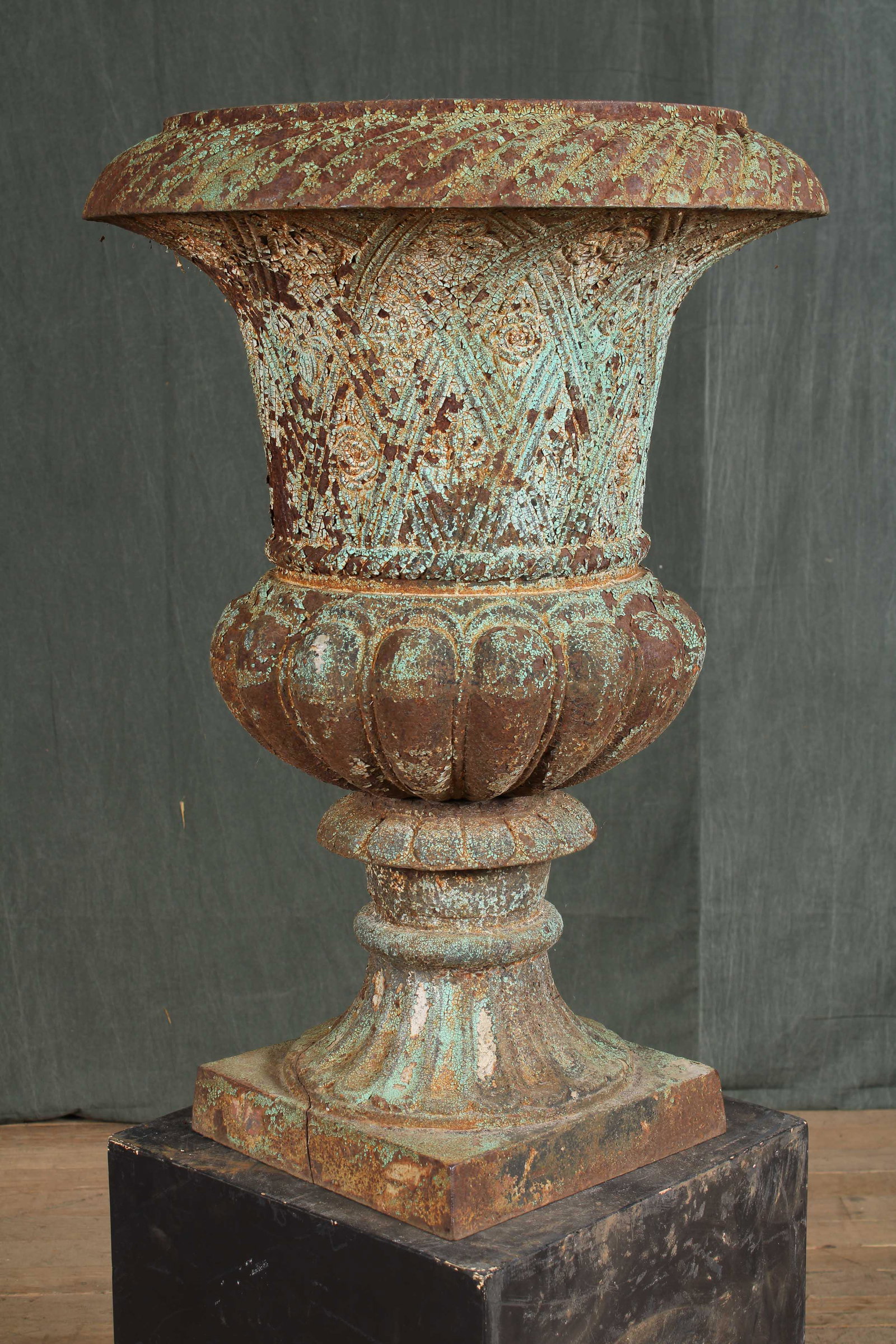 Large Cast Iron Garden Urn: A large cast iron garden urn having basket weave decorated bowl. Good looking with remnants of old paint surface. Size: 32"H x 21"Dia.