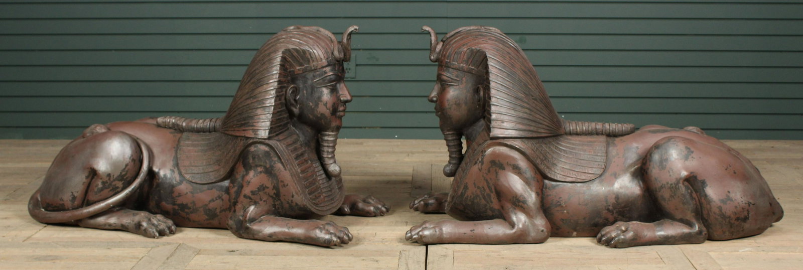 Pair of Large Bronze Sphinx Form Garden Figures: A very good pair of large bronze sphinx garden figure in the Egyptian Revival style each having classic head dress with snake ornament over a chest plate on the body of a lion. Size: 26"H x 48"W x 22"