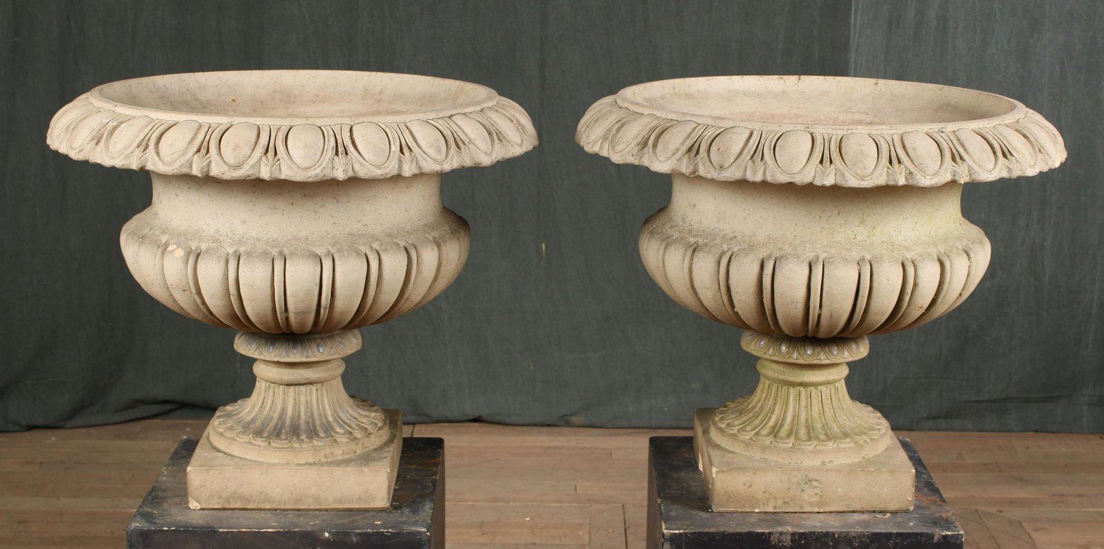 Pair Galloway Philadelphia Terracotta Urns: Pair of stamped Galloway Philadelphia buff terracotta classical urns each having egg and dart decorated rims over melon form bowl all raised on stepped base.