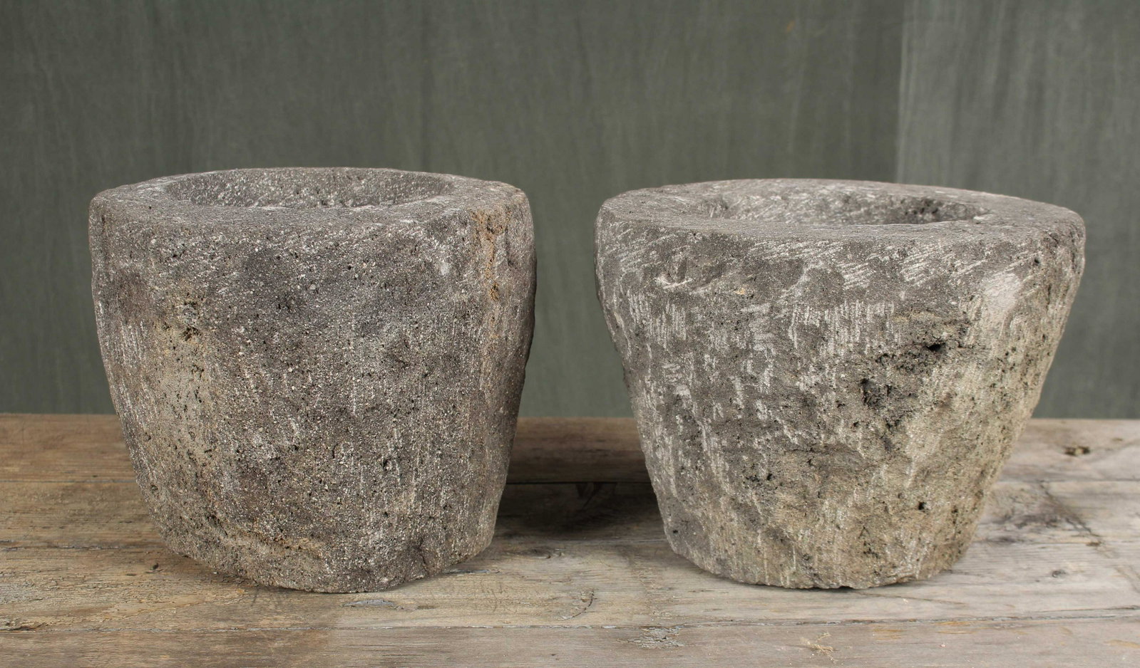 Pair Carved Lava Stone Garden Ornaments: A pair of carved stone garden urns possibly original crucibles or mortars. Size: 8.5"H x 12"Dia.