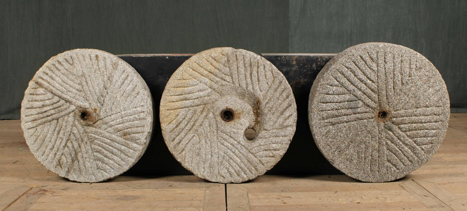 Mill Stones: A lot of three carved stone mill stones of various sizes. Largest size: 5"H x 22"Dia