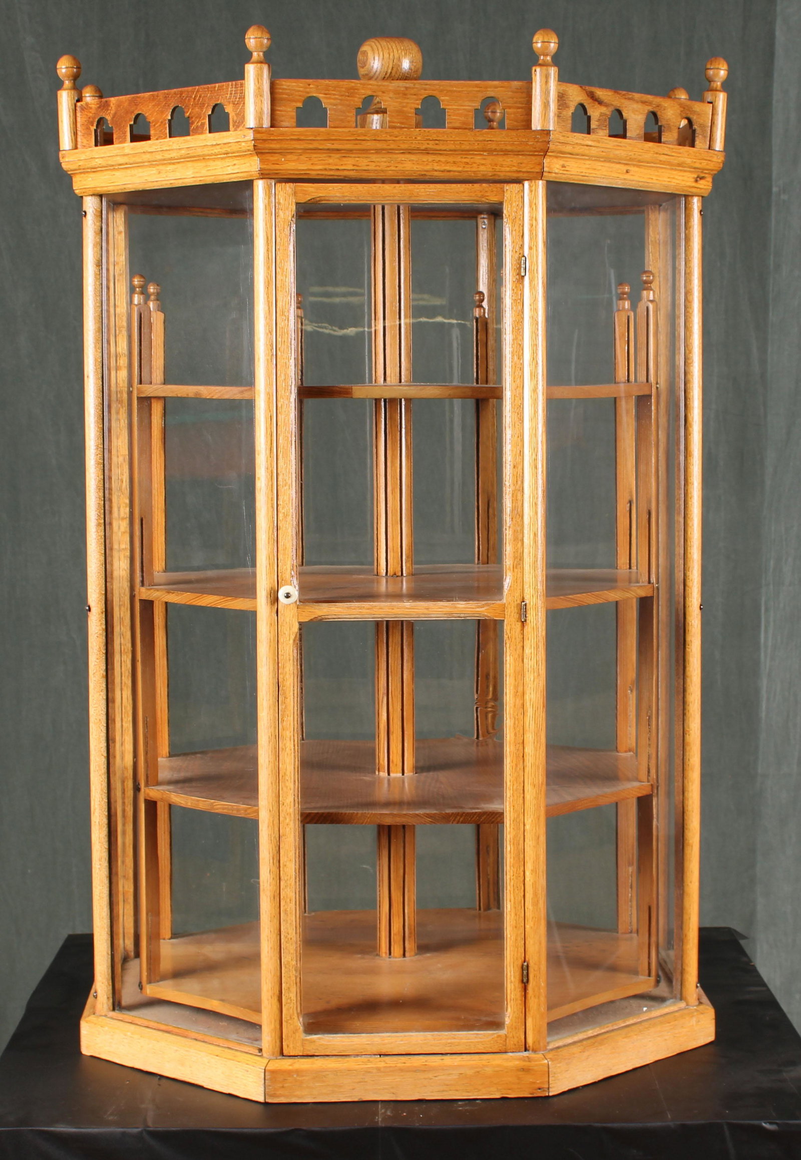 J.G. Schumnn Rotating Cabinet: A labeled J.G. Schumm late 19th century octagonal glass sided display case having interior rotating shelves. Size: 44"H x 29"W x 29"D