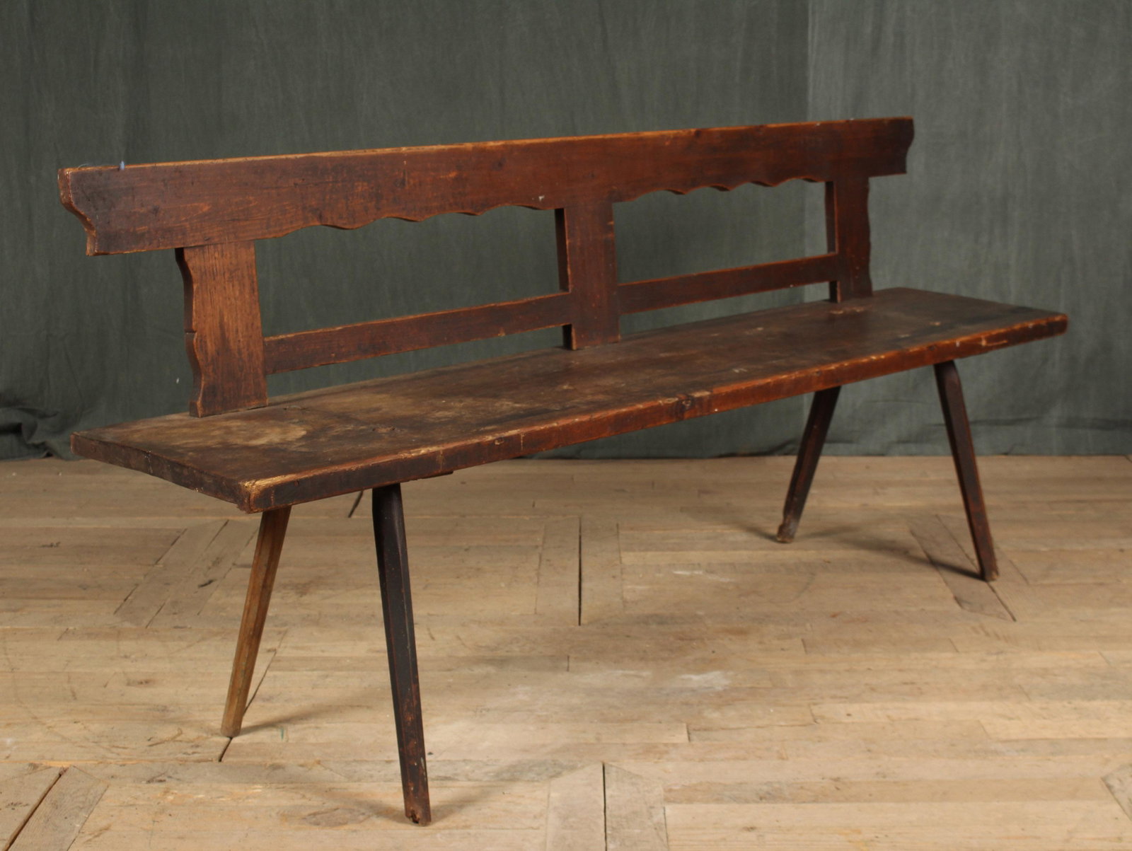 Continental 19th C Country Bench: An antique Continental plank seat country bench having carved back and splayed legs. Size: 33.5"H x 75"W x 16"D