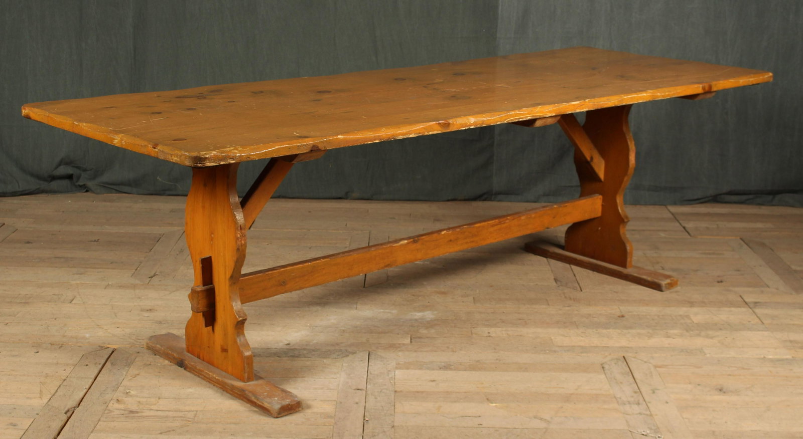 Country Trestle Base Table: A country dining table having shaped edge top supported on a trestle base with central stretcher. Great size. Size: 30.5"H x 98"W x 35"D