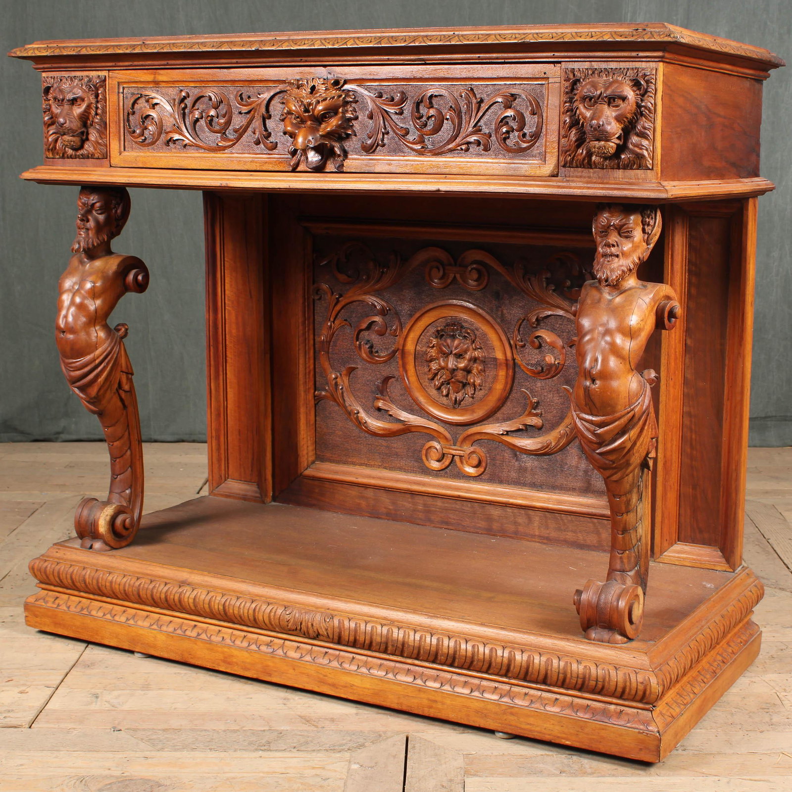 19th C Grotesques Motif Console: A good late 19th century carved figural console table having single drawer with central griffin head flanked by lion mask all supported by carved caryatids with scroll bases raised on plinth base. Siz