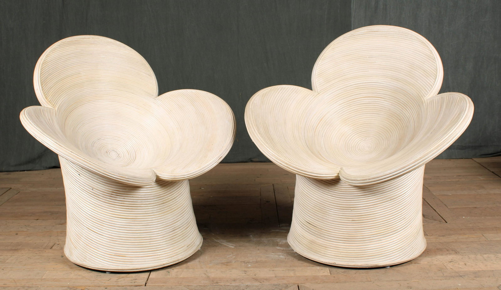 Pair Pencil Reed Petal Form Patio Chairs: An interesting pair of Pencil Reed chairs each having petal form design back and saucer seat. Size: 35"H x 35"W x 27"D
