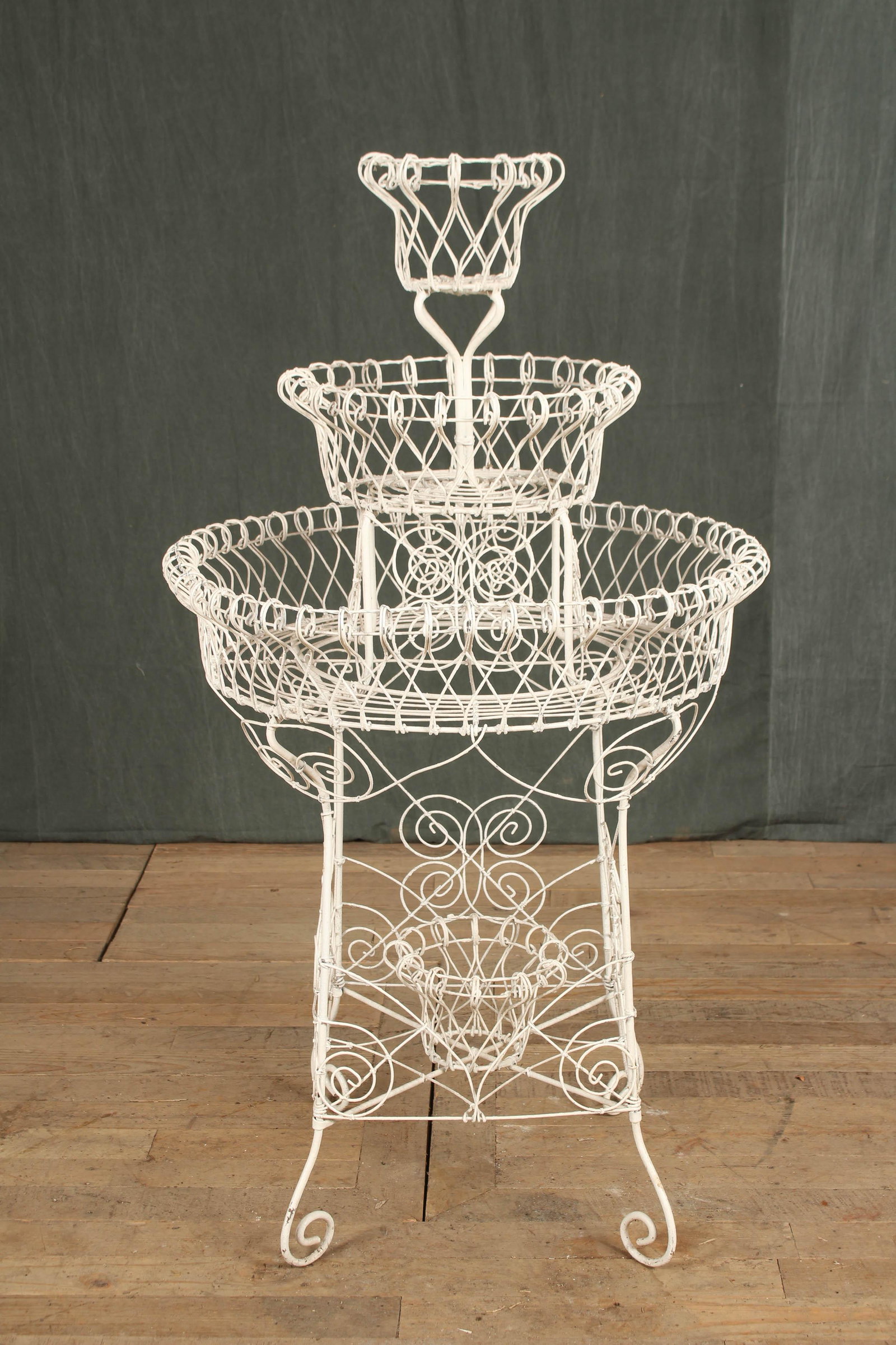 Early 20th C Wirework Plant Stand: An early 20th century wirework garden planter with 3 tiers of baskets. Size: 45" H x 26" W x 26" D